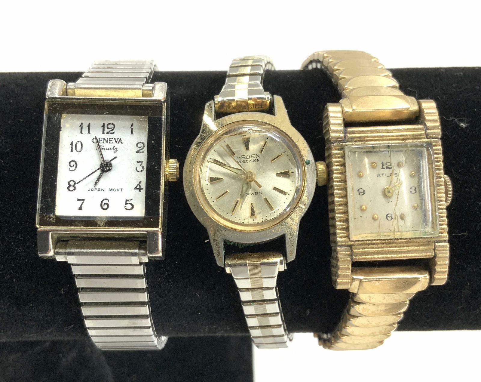3 Stretch Band Watches- Atlas, Geneva, Gruen: Silver tone and gold tone vintage stretch band cocktail watches. Atlas, Gruen, and Geneva. Wear to a couple of Watch face glass. All Stretch 4.25 in. Largest watch case is Geneva, 3/4 x 1 1/8 in. Vint