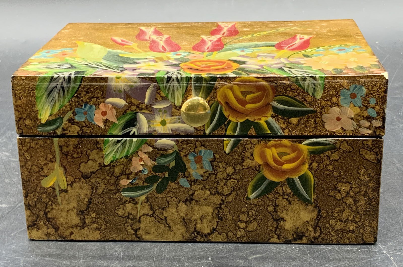 Vintage Floral Motif Lacquered Wood Trinket Box: A vintage multicolored floral motif lacquered wood trinket box. Lined soft hand fabric interior. Opens with hinge hardware. Measures approx. 3.25H x 6.25W in. Chipping and surface wear present. Collec