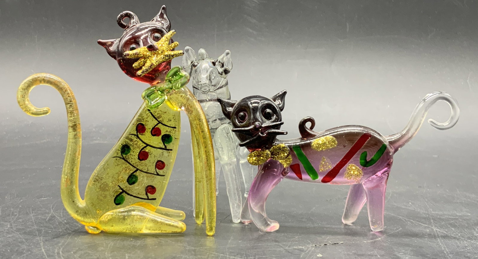 3 Art Glass Cat Pendants & Art Glass Zebra Figural: Two handcrafted multicolored art glass cat pendants and one art glass zebra figural. Glitter to the cat pendants. The tallest cat pendant measures approx. 3L x 2.5W in. Some bubbles to the glass and i