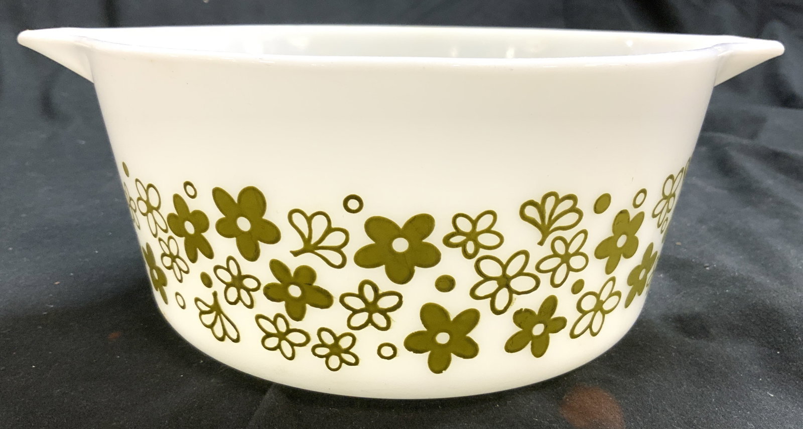 PYREX BY CORNING Glass Serving Bowl Vessel: Underside reads PYREX BY CORNING. Bowl is white toned glass with olive toned floral detail. Sides of vessel have handles. Piece measures approximately 9.25 inches wide 7.5 inches deep 3.5 inches tall.