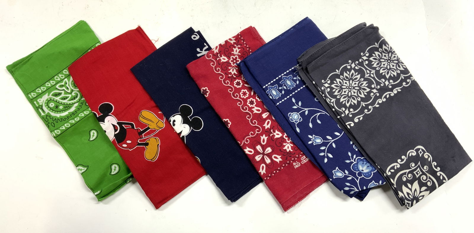 Lot 6 Bandanas, Mickey Mouse & More: Lot includes 6 bandanas. Some depicting Mickey Mouse, others with floral or paisley patterns. One marked 100% Cotton. Largest measures approx 20 inches square. fashion accessories, wearables, 6s