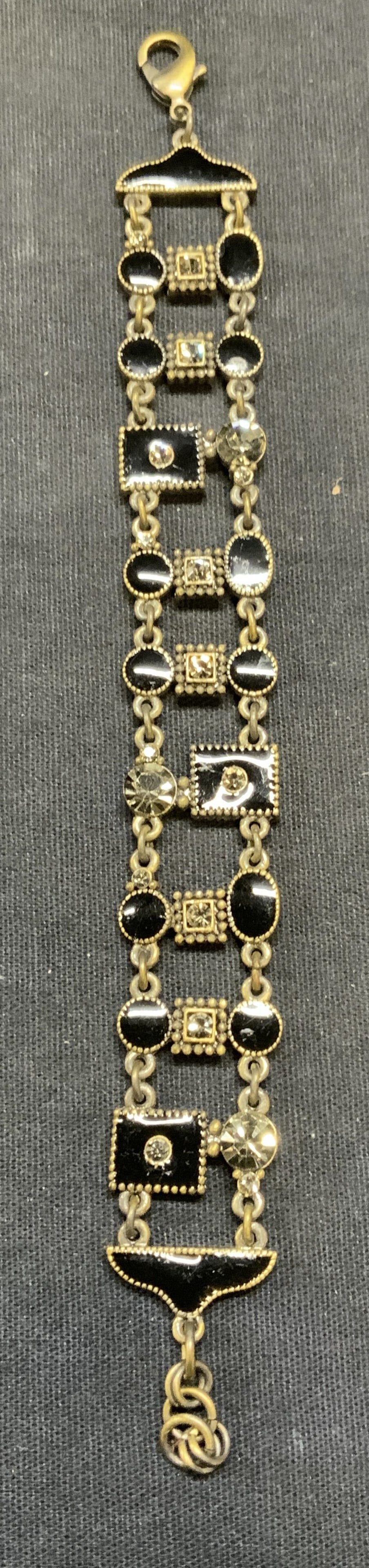 Gold Tone Enameled Crystal Bracelet: Gold tone black enameled panel bracelet with crystal decoration. Measures approx. 7 inches long. One piece of panel needs repair. Some surface wear including scratching observed. Estate jewelry, costu