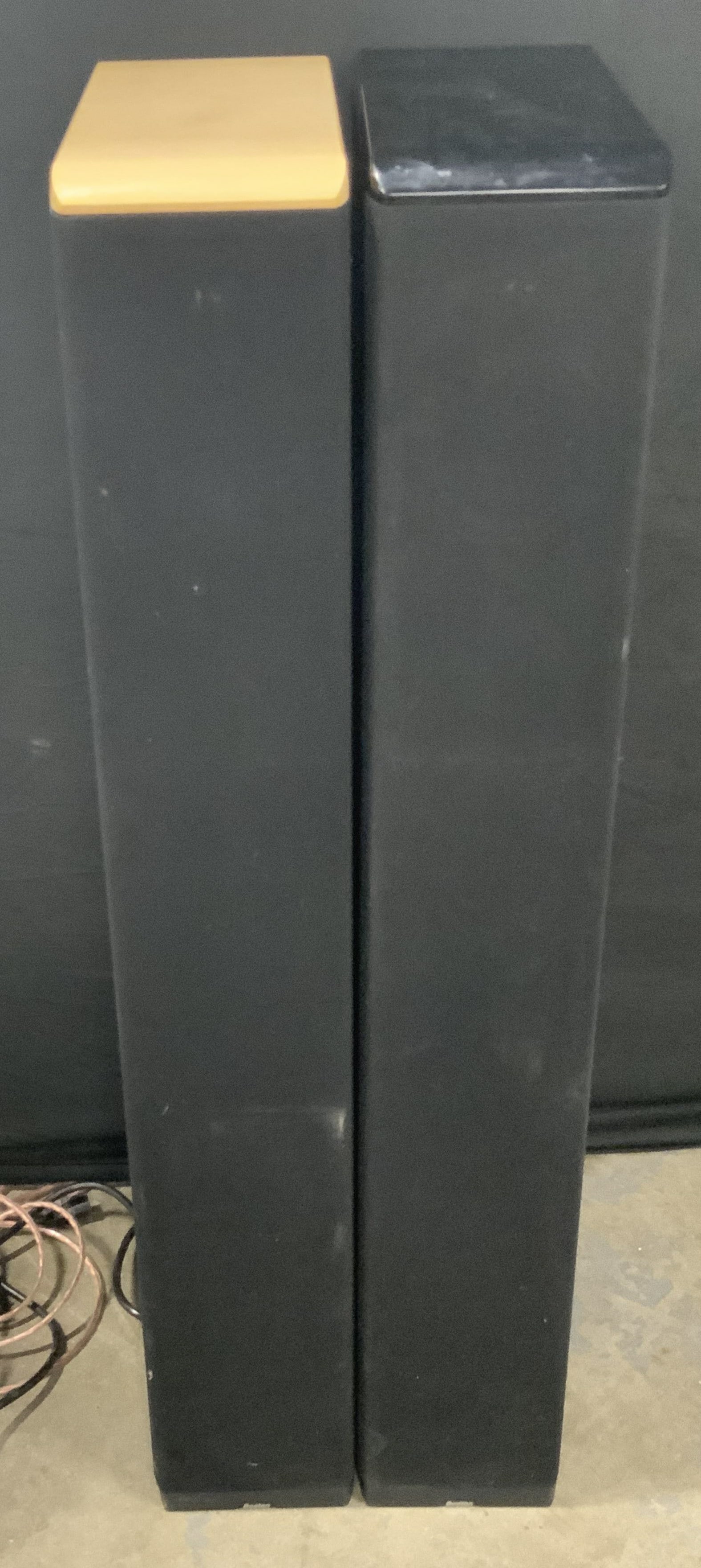 Pair BOSTON Black Speakers: A pair of standing black speakers. Rectangular form. Base reads BOSTON. Comes with wires, possibly original wires. Measures approx. 42H x 14D x 6.5W in. Not tested for function. One piece is missing b