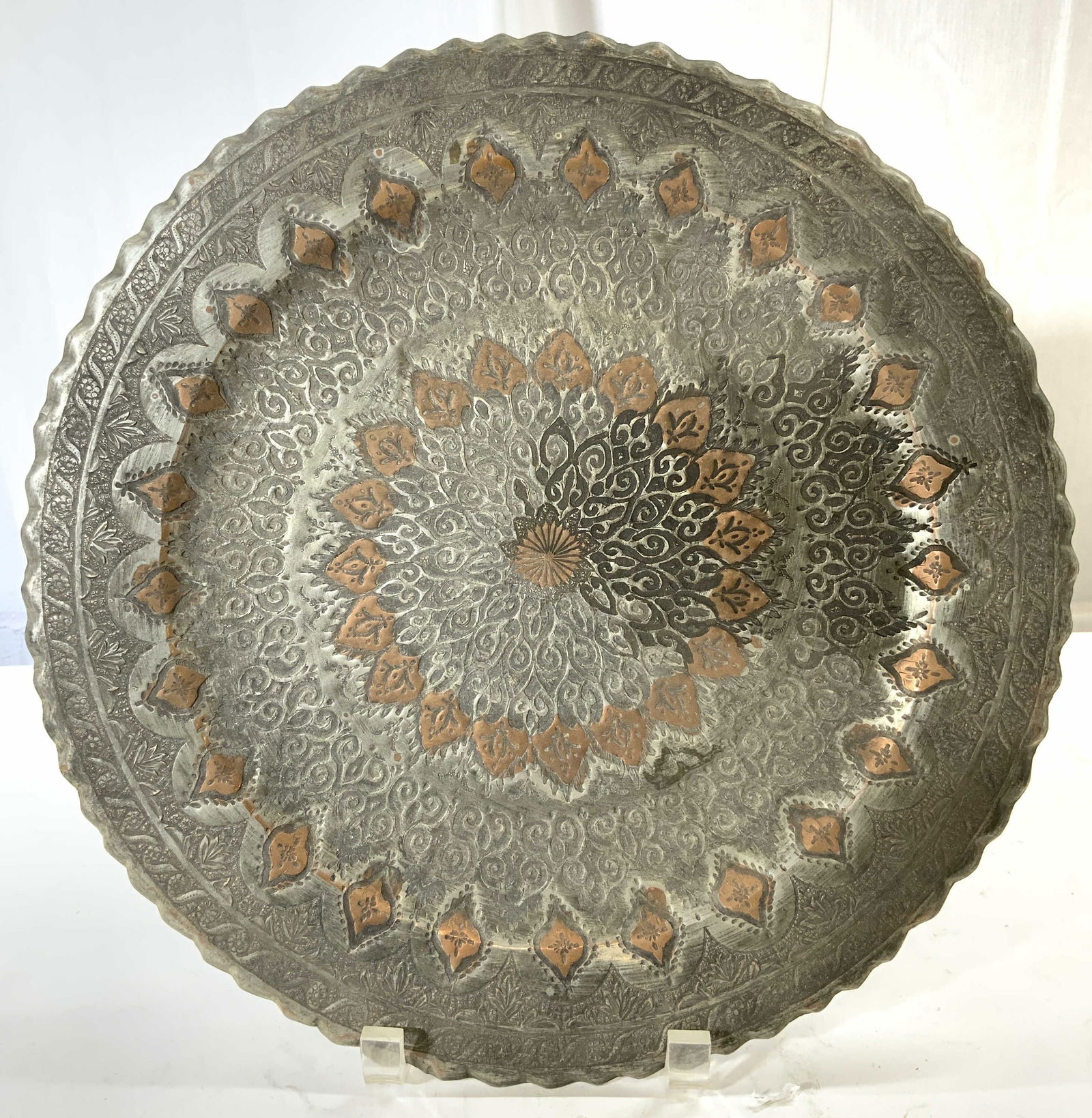 Vintage Metal & Copper Wall Relief: Wall relief appears to be metal possibly pewter & copper. Piece has intricate leaf, curl & geometric detail. Relief has scalloped edges. Wall relief is vintage. Piece measures approximately 13.5 inche