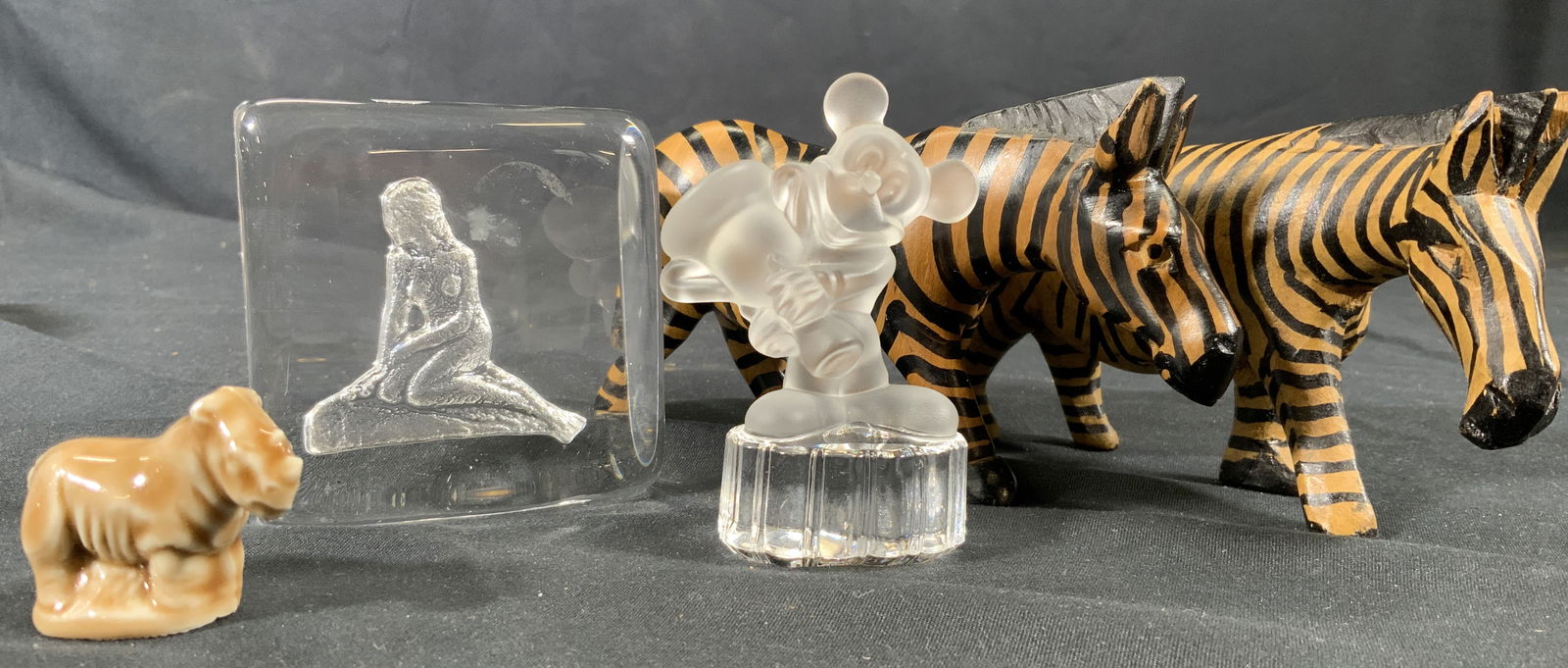 Lot5 Tabletop Wood & Glass Decor Goebel: Miscellaneous desk or tabletop decor. Two wooden zebra figurines. Figurines each measures approx. 5.5 W x 3 H x 2 D in. Miniature ceramic glazed rhinoceros. Textured underside for grip. Goebel Germany