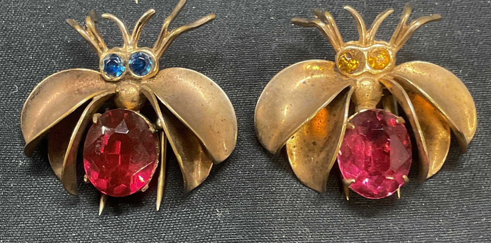 Pair Vintage Gold Tone Crystal Fly Sweater Clips: Pair of vintage gold tone fly motif sweater or dress clips with pink, blue, and orange crystal decoration. Measure approx. 1 x 1.25 inches each. Some surface wear to each including scratching observed