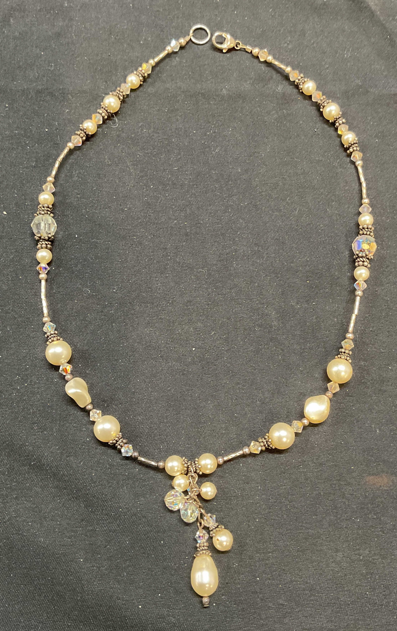 Sterling Silver, Crystal & Faux Pearl Necklace: Sterling silver, crystal, and faux pearl pendant necklace. Marked 925 on clasp. Drop length approx. 7.5 inches. Total weight 22.2 grams. Some surface wear including scratching observed. Jewelry, estat