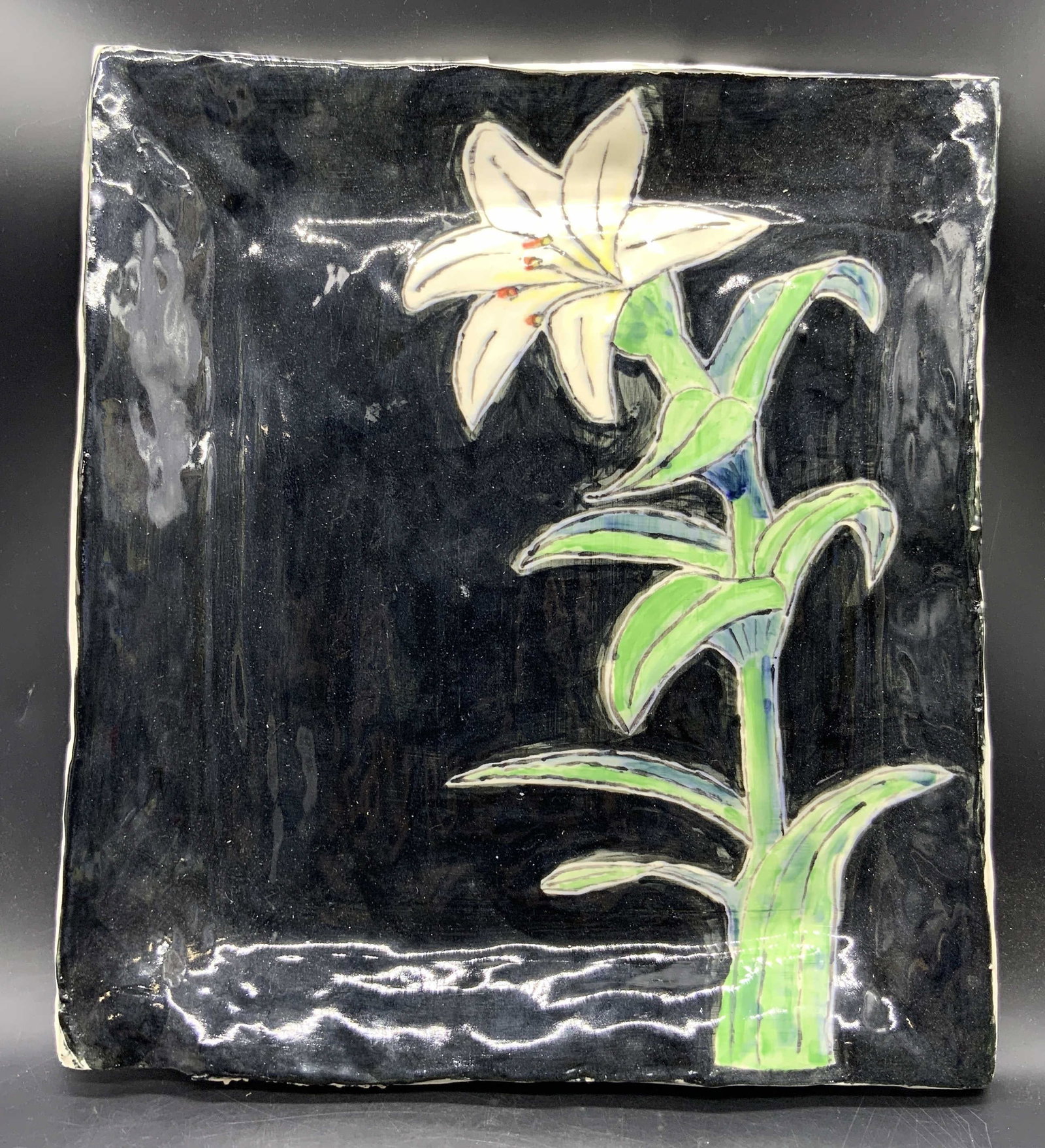 Artist Sig Handmade Floral Motif Pottery Platter: A handmade floral motif pottery platter. Obverse is blue, green, and white painted & glazed hues. Rough edges and rectangular form. Sides and underside are not painted. Side signed by artist, illegibl