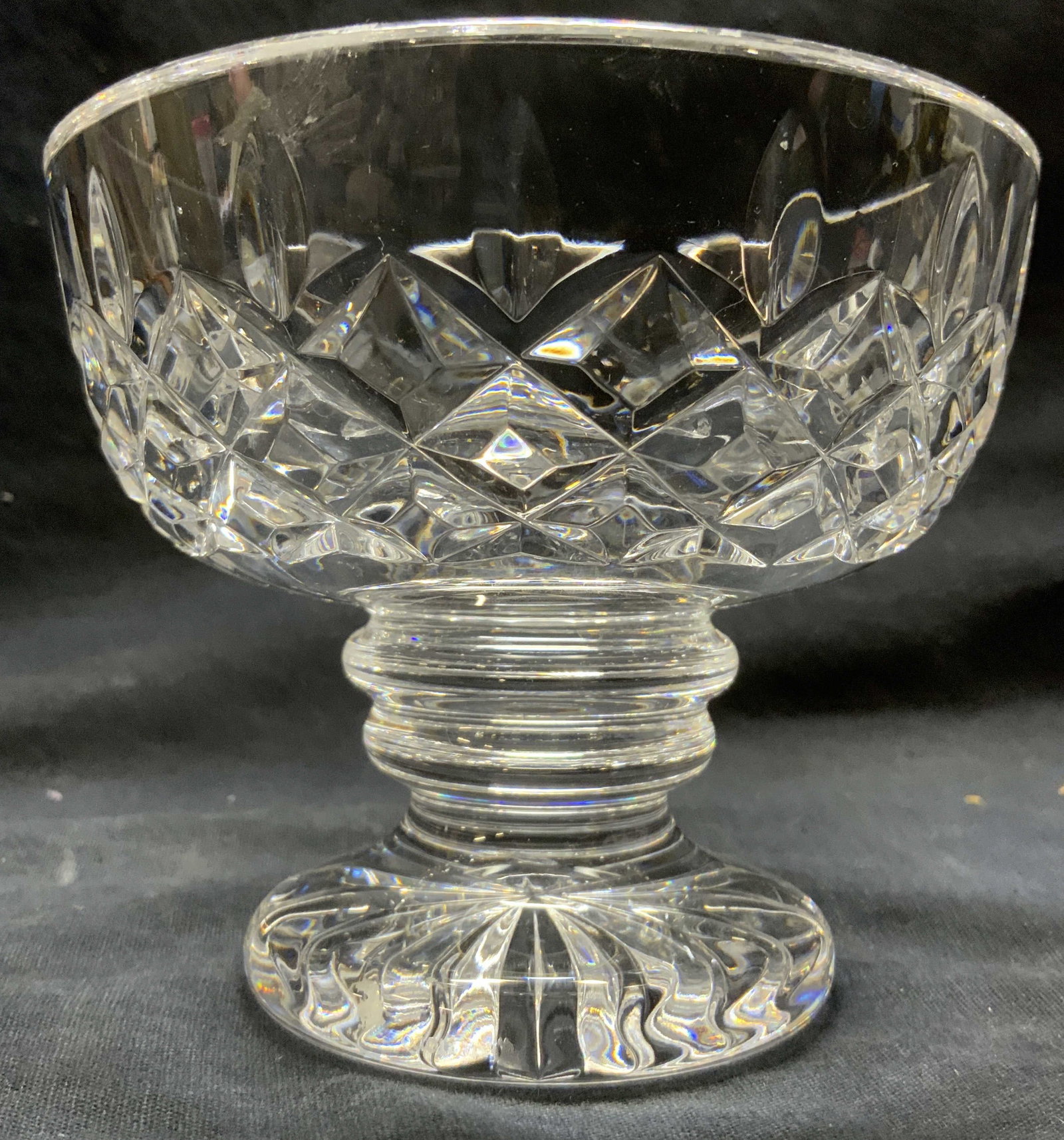 WATERFORD Pedestaled Crystal Bowl Vessel: Vessel is signed WATERFORD at base. Vessel is cut crystal. Bowl is pedestals. Piece has geometric relief detail. Vessel measures approximately 4 inches tall 5 inches diameter. Vessel, bowl, crystal bo