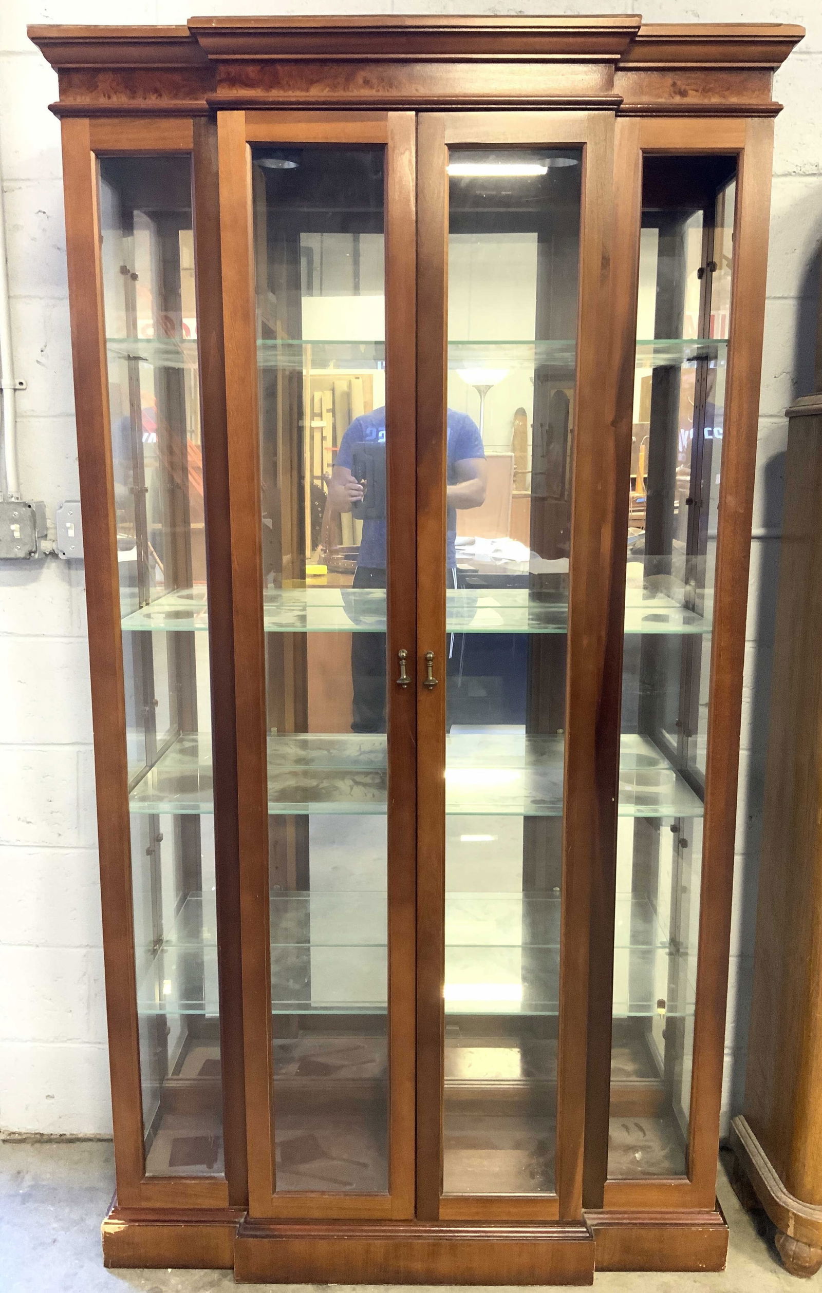 Wooden Curio Cabinet W Glass Shelves: Curio cabinet is light brown toned and wooden. Piece has glass front & side windows. Doors have teardrop form pulls. Cabinet has 4 glass shelves. Measures approx 76 inches tall 43 inches wide 12.5 inc