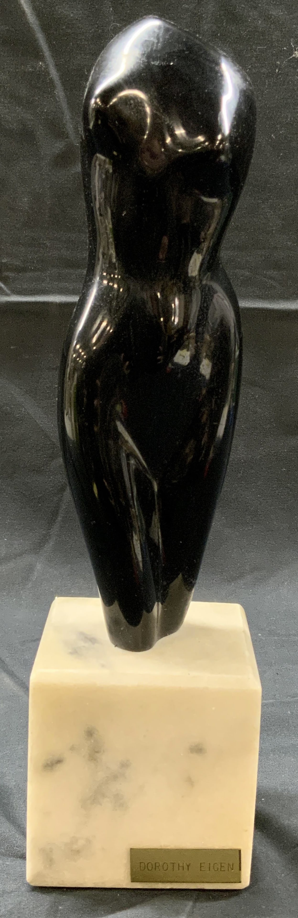 Dorothy Eigen Abstract Nude Figure Statue: Composite statue on marble base. Small plaque on marble base reads Dorothy Eigen. Statue depicts an abstract nude female figure with no head or arms. Statue measures approx. 3 W x 12 H x 3 D in. Felte