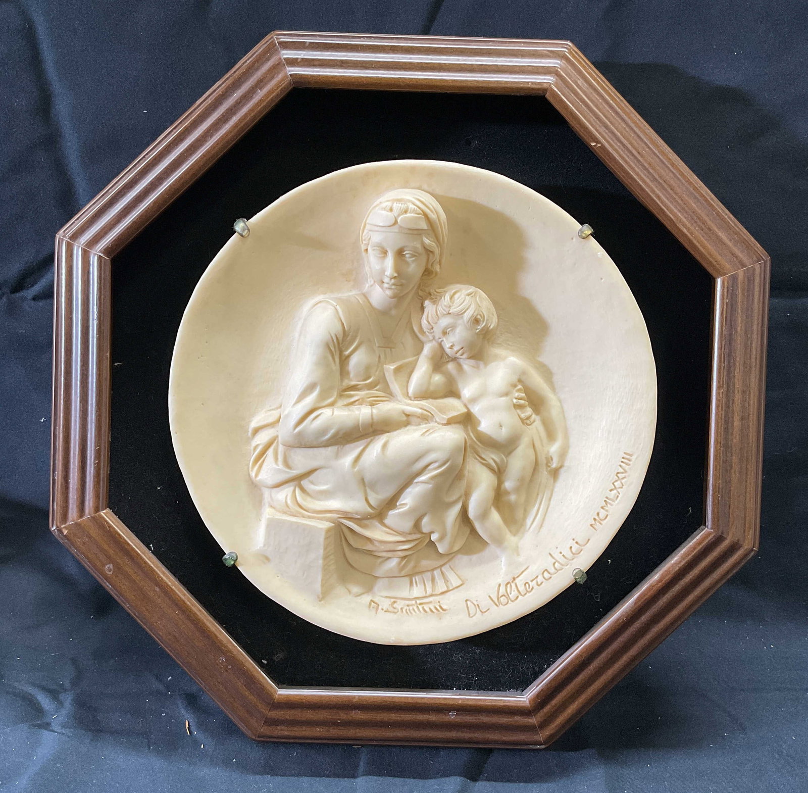 A Santini Di Volteradici Madonna Pensosa Plate: Alberto Santini, Studio Dante Di Volteradici, Madonna Pensosa hand carved ceramic stone plate. Madonna and child motif carved in relief. Signed and dated along rim. Produced 1978. Made in Italy. Frame