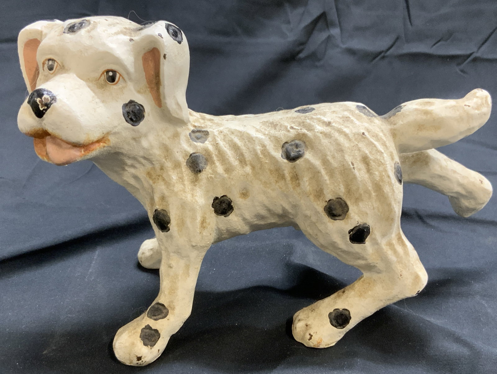 Antq Cast Iron Dalmatian Door Stop: Door stop appear to be antique possibly vintage. Piece depicts a Dalmatian dog, white with black toned spots with 1 rear leg raised in air. Piece is cast iron. Door stop measures approximately 10 inch