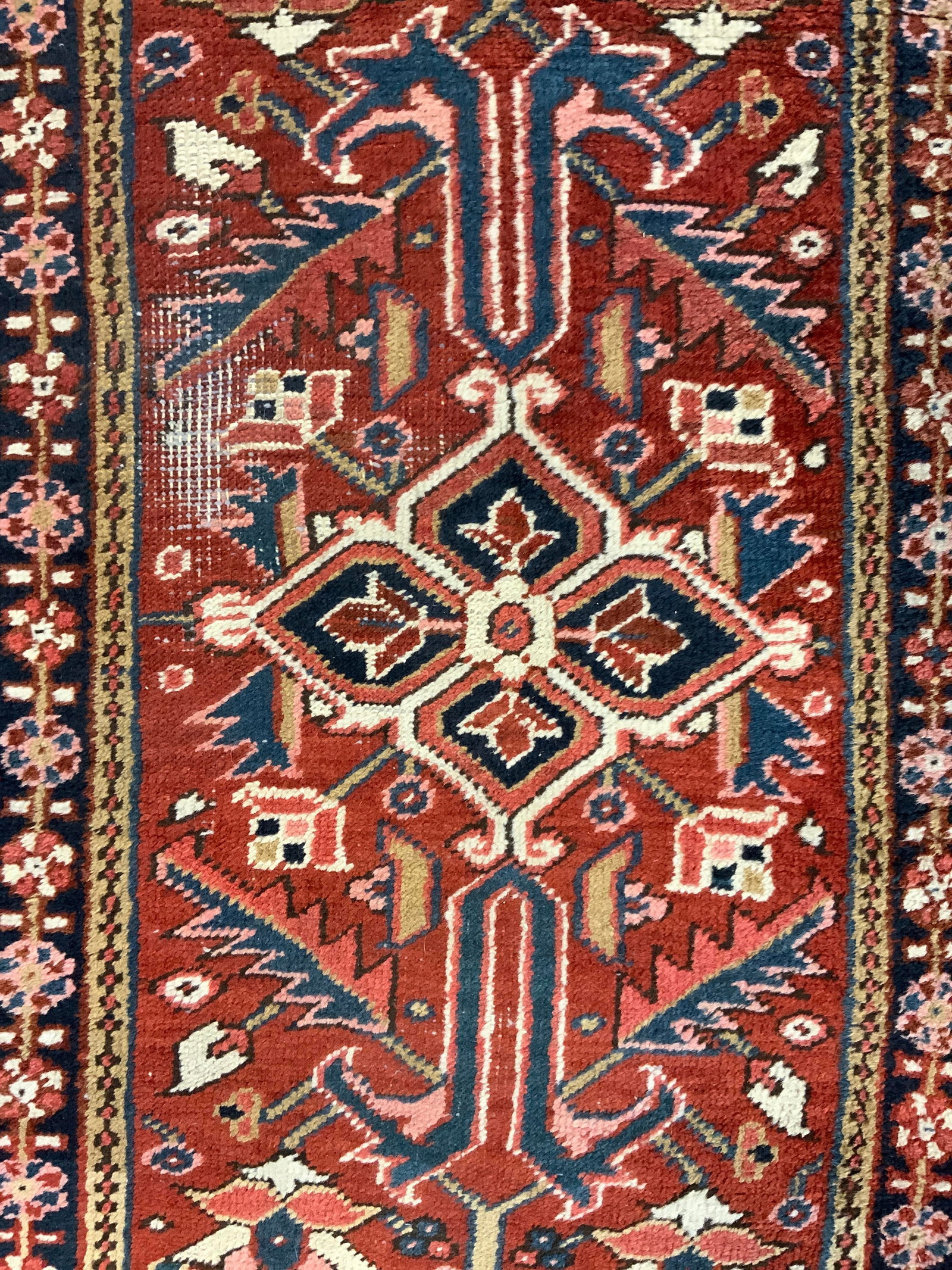 RUGS PERSIA Handmade Persian Fringed Wool Rug: Tag on underside reads RUGS PERSIA. Rug is handmade & wool. Piece has intricate multi toned floral, leaf & geometric detail. Rug has cream toned fringes at edges. Piece measures approximately 68 inche
