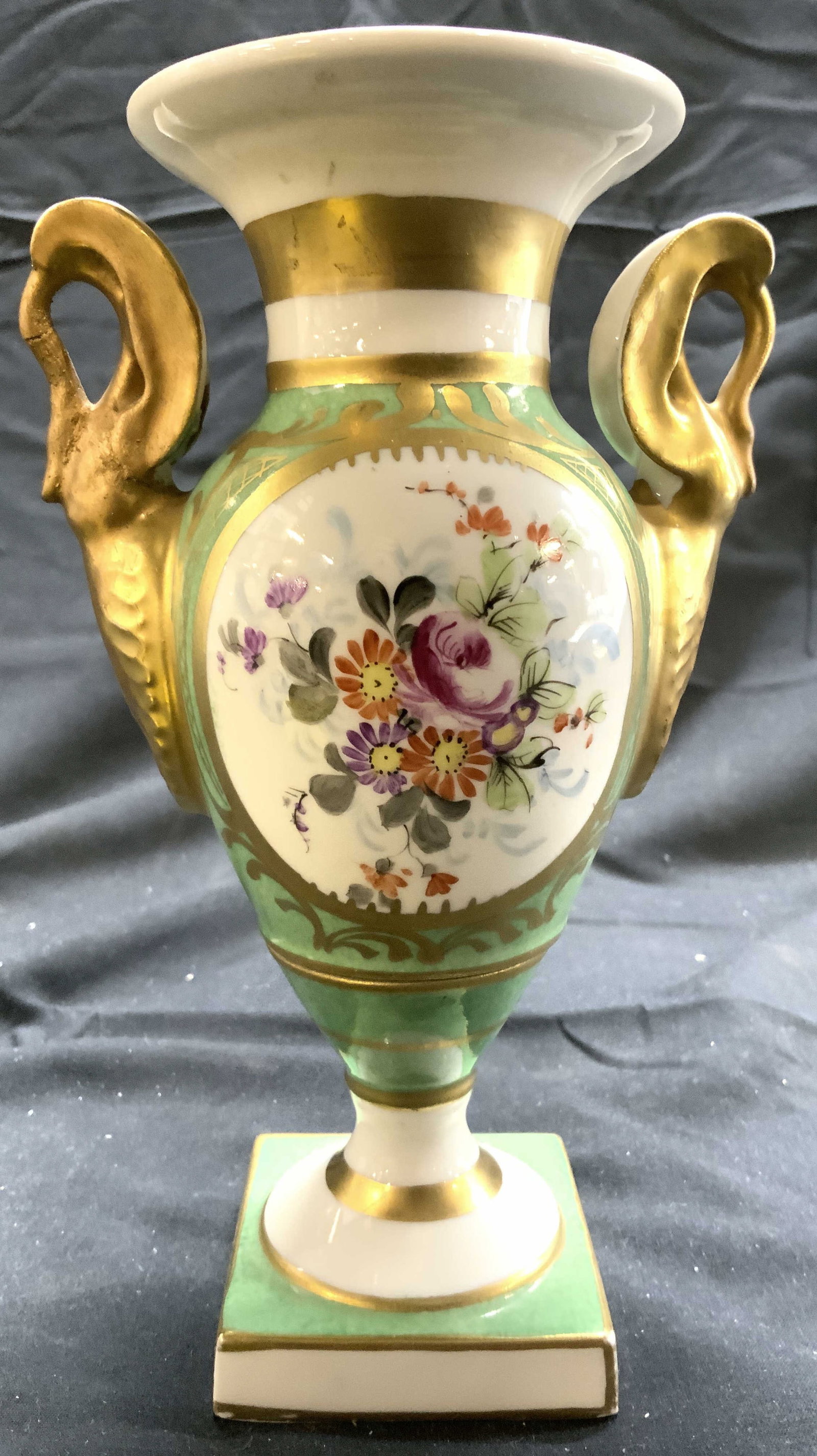 LIMOGES FRANCE Vintage Porcelain Vase W Handles: Underside is marked LIMOGES FRANCE. Vase is porcelain. Piece has intricate multi toned floral and leaf detail. Vase has gilt handles and other gilt detail. Vessel measures approximately 7.75 inches ta