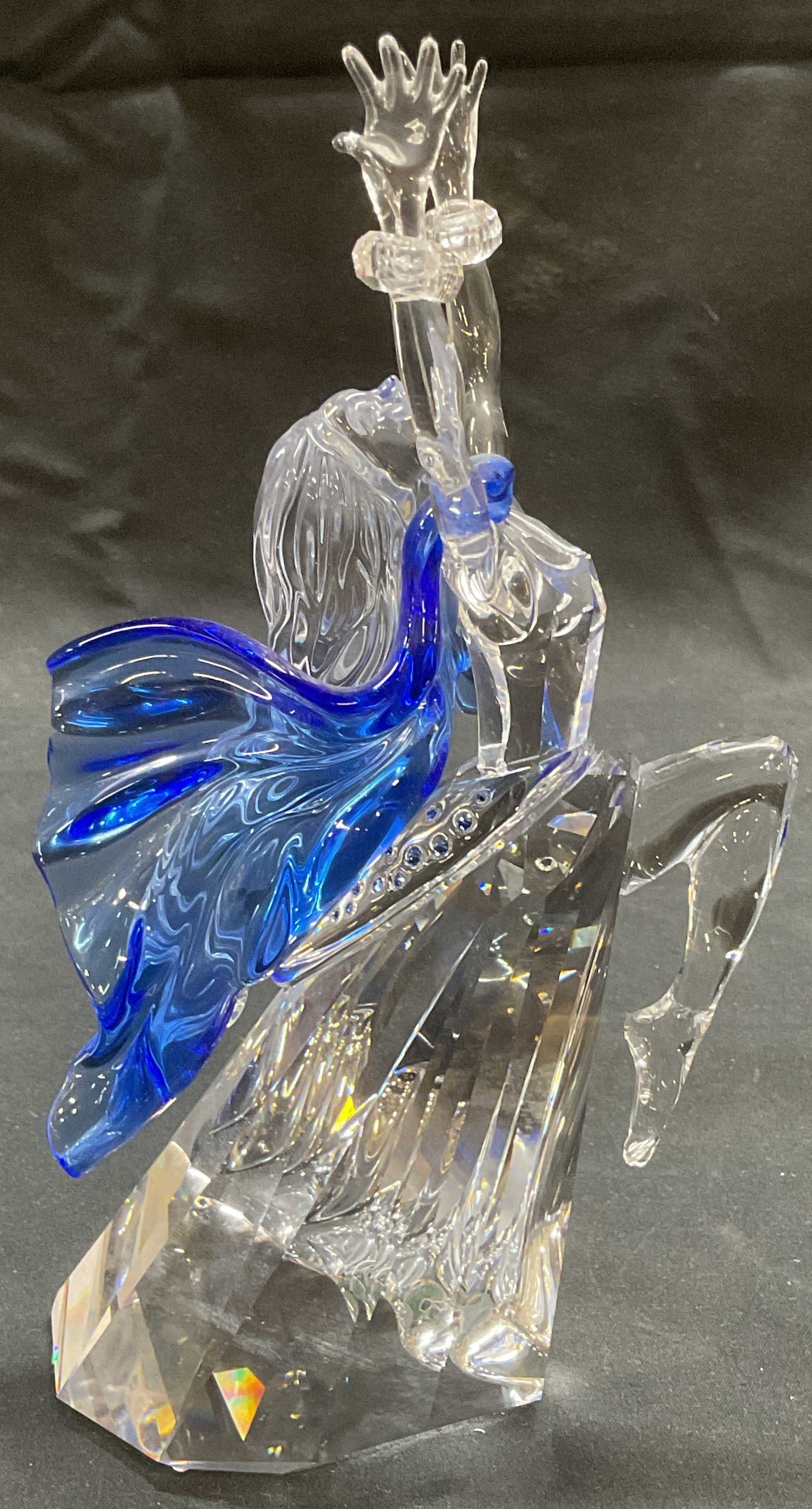 Swarovski Crystal Magic of Dance Isadora Figural: Swarovski Crystal Magic of Dance series Isadora figural. Woman arms and leg raised in dance movement. Clear and blue cut crystal. Signed to underside. Produced 2002 Piece has weight. Measures approx. 