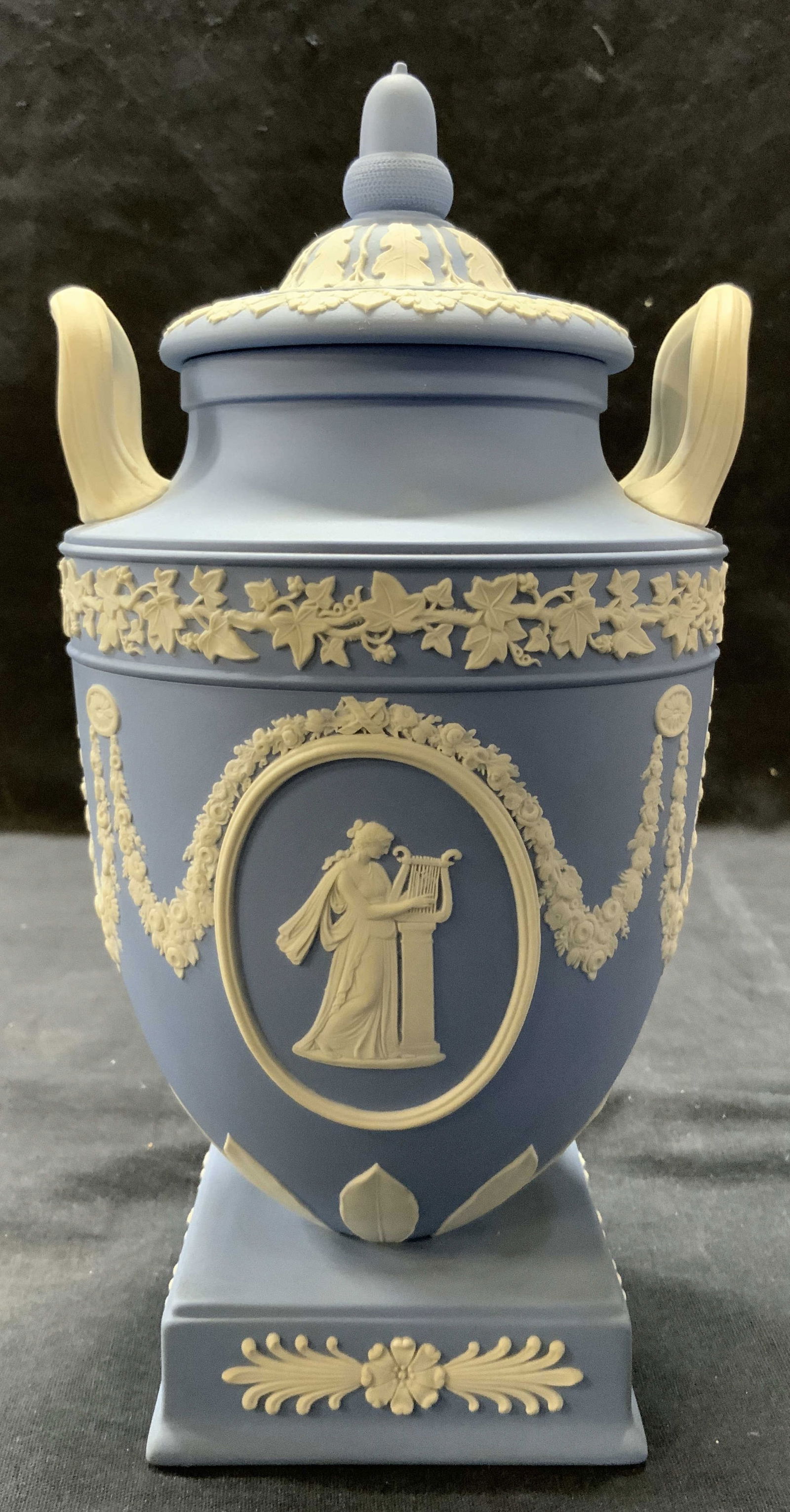 WEDGWOOD Jasperware Urn W Lid ENGLAND 1956: Underside inscribed WEDGWOOD MADE IN ENGLAND Jasperware covered urns, Wedgwood blue ground with medallions featuring the muses Tepischore - with the harp - and Thalia - with the dramatic mask - respec