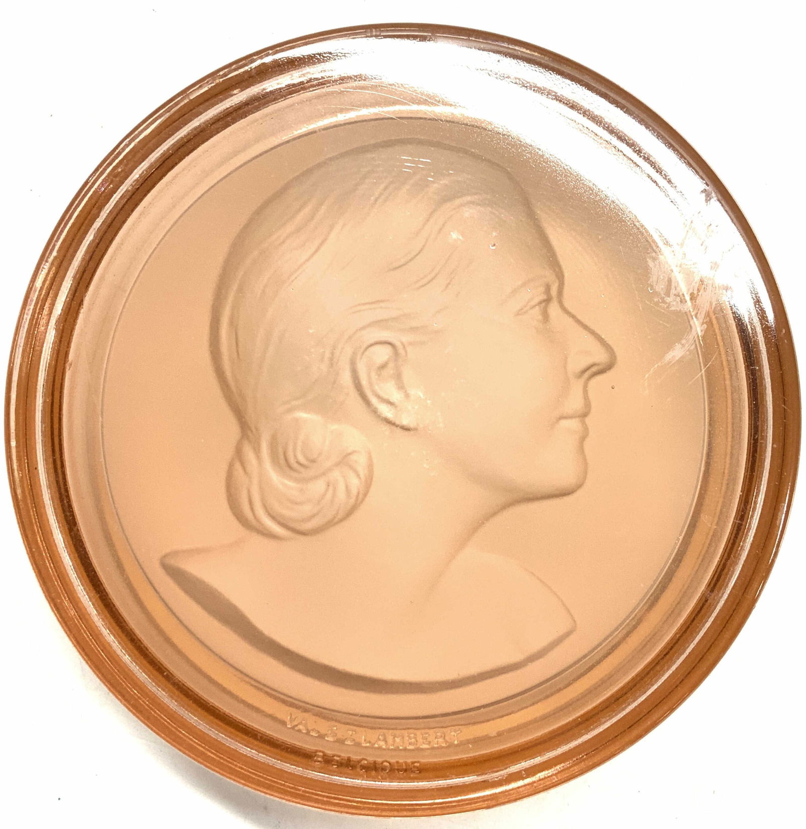 Val St Lambert Signed Glass Dresser Box, Belgium: Pink glass dresser box, signed Val St Lambert and Belguique. Impressed cast profile of a woman. Measures 4.75 in. Diameter x 2 in. Ht.. minor chip on underside of lid rim. Val st Lambert Glass Box, Va