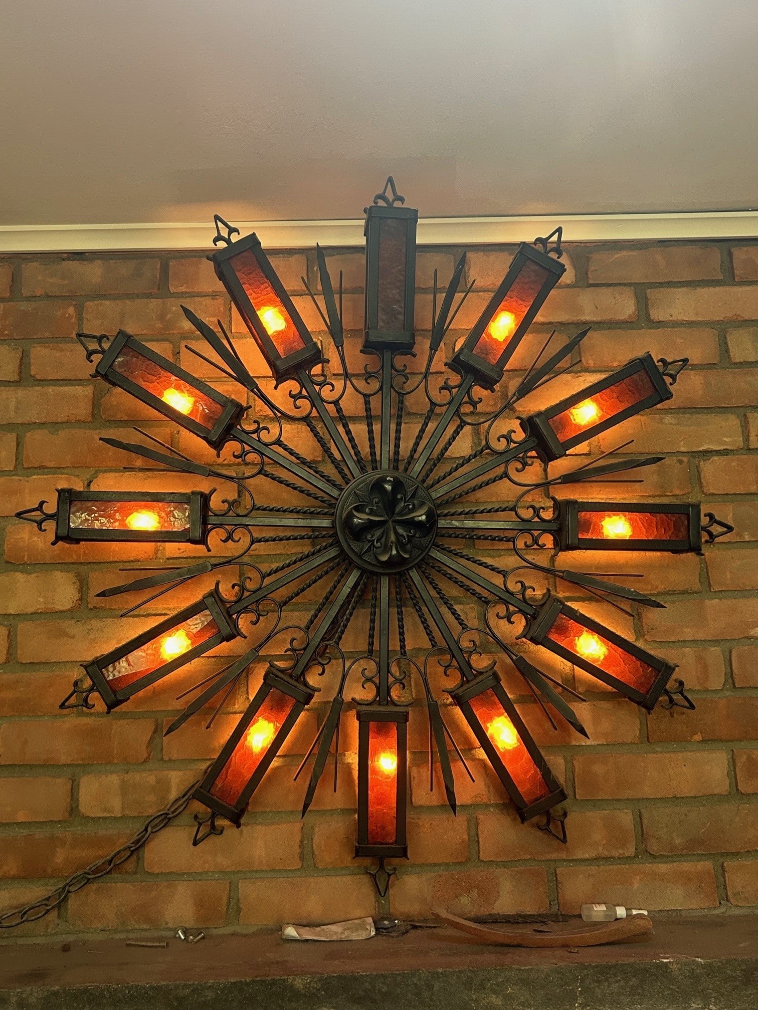 Vintage Art Glass & Metal Wall Lighting Fixture: A vintage art glass and metal wall lighting fixture. Dark metal with deep amber glass panels. Twelve lights. Measures approx 36 in by 36 in. Cracking to glass present. Not tested for function outside 