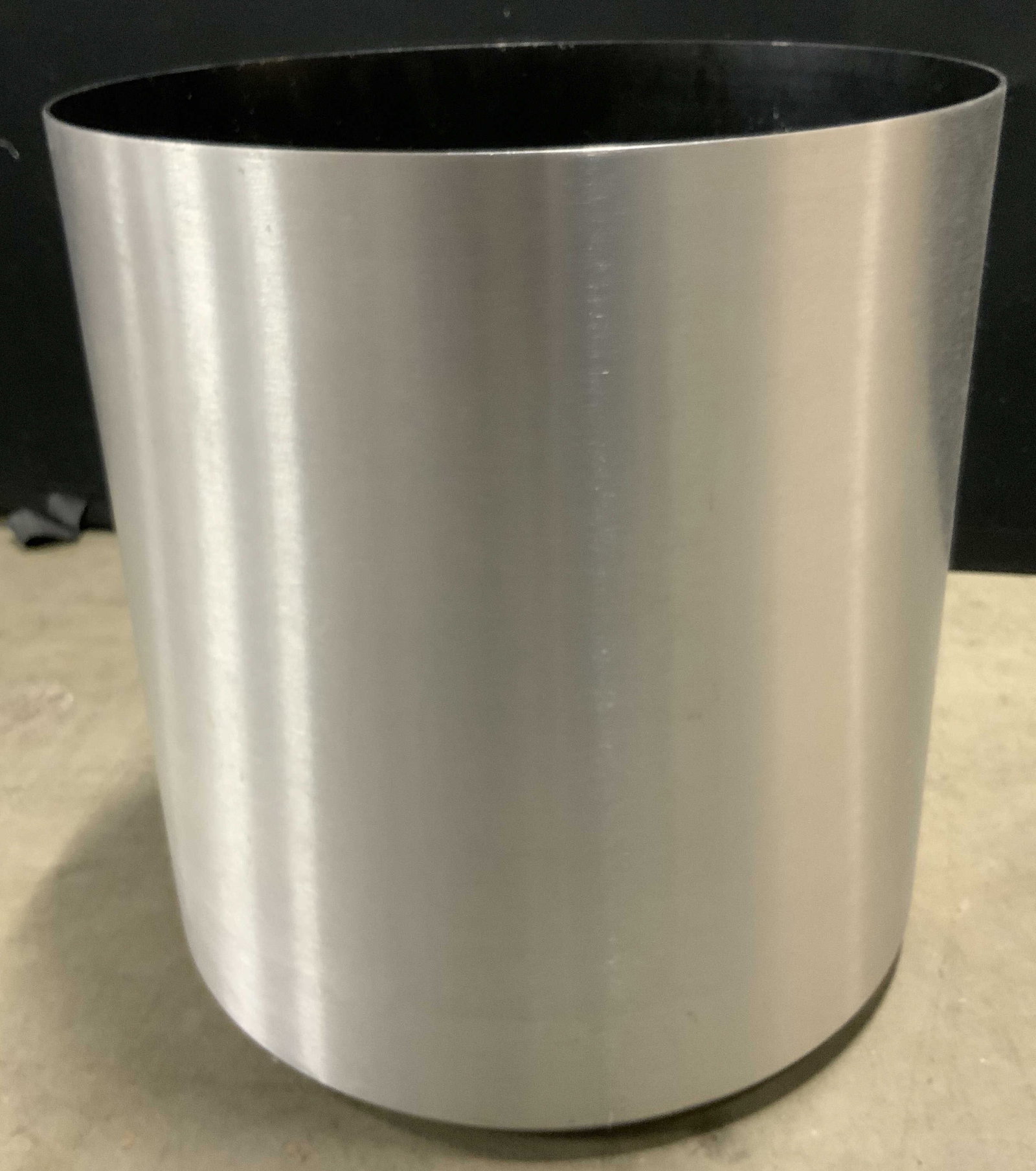 Mid Century Mod Brushed Aluminum Planter, CANADA: A mid century modern brushed aluminum planter. Black finished interior. Measure approx. 13H x 12W in. Underside reads MADE IN CANADA. Some losses to interior finish. Some surface wear consistent with 