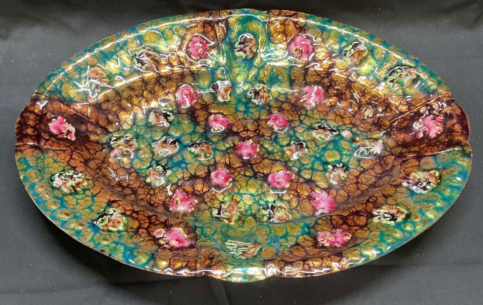 Vintage Limoges Enameled Copper Bowl, France: Vintage signed Limoges bowl with abstract floral motif. Raised surface detail. Enamel over copper. Hues of green, pink. Brown, gold, and blue. Signed to underside. Made in France. Measures approx. 14