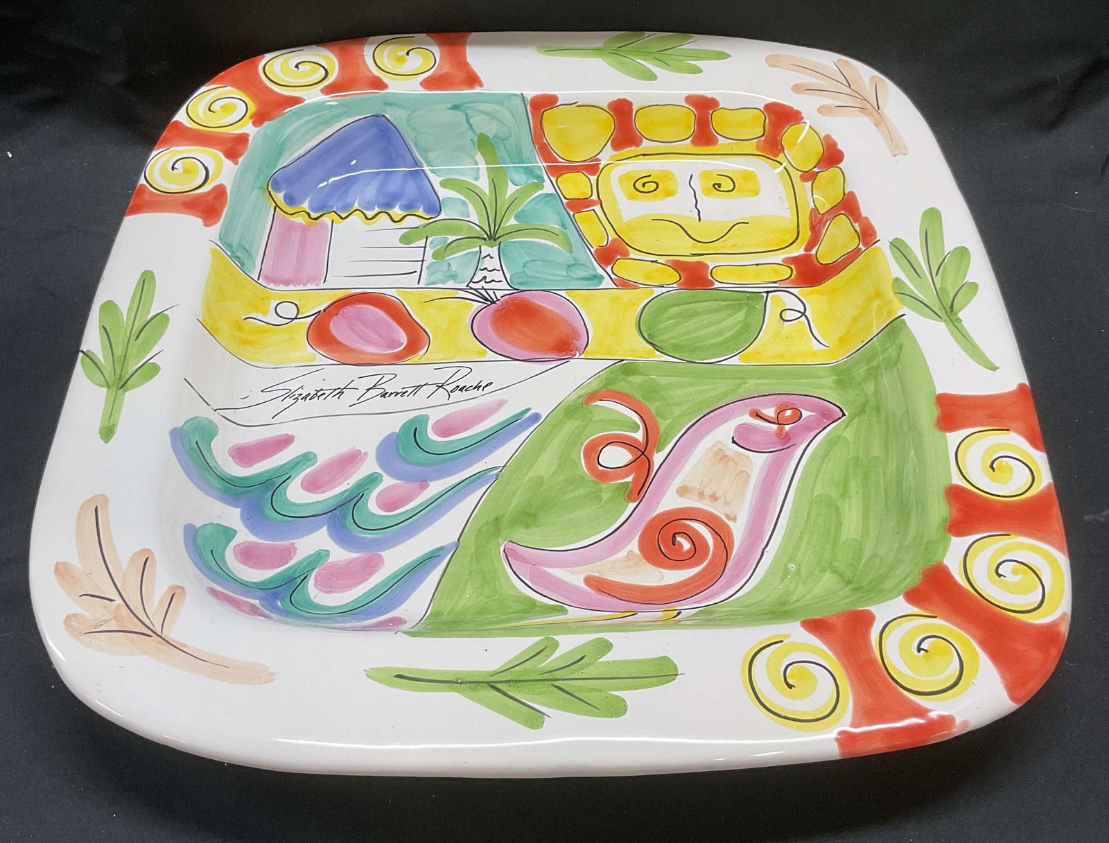 1991 Elizabeth B. Roache Ceramic Platter, Italy: Vintage 1991 Elizabeth Barrett Roache ceramic square platter. Hand painted with bird, sun, and house motif in hues of pink, green, yellow, and orange. Signed in front and underside. Marked for Present