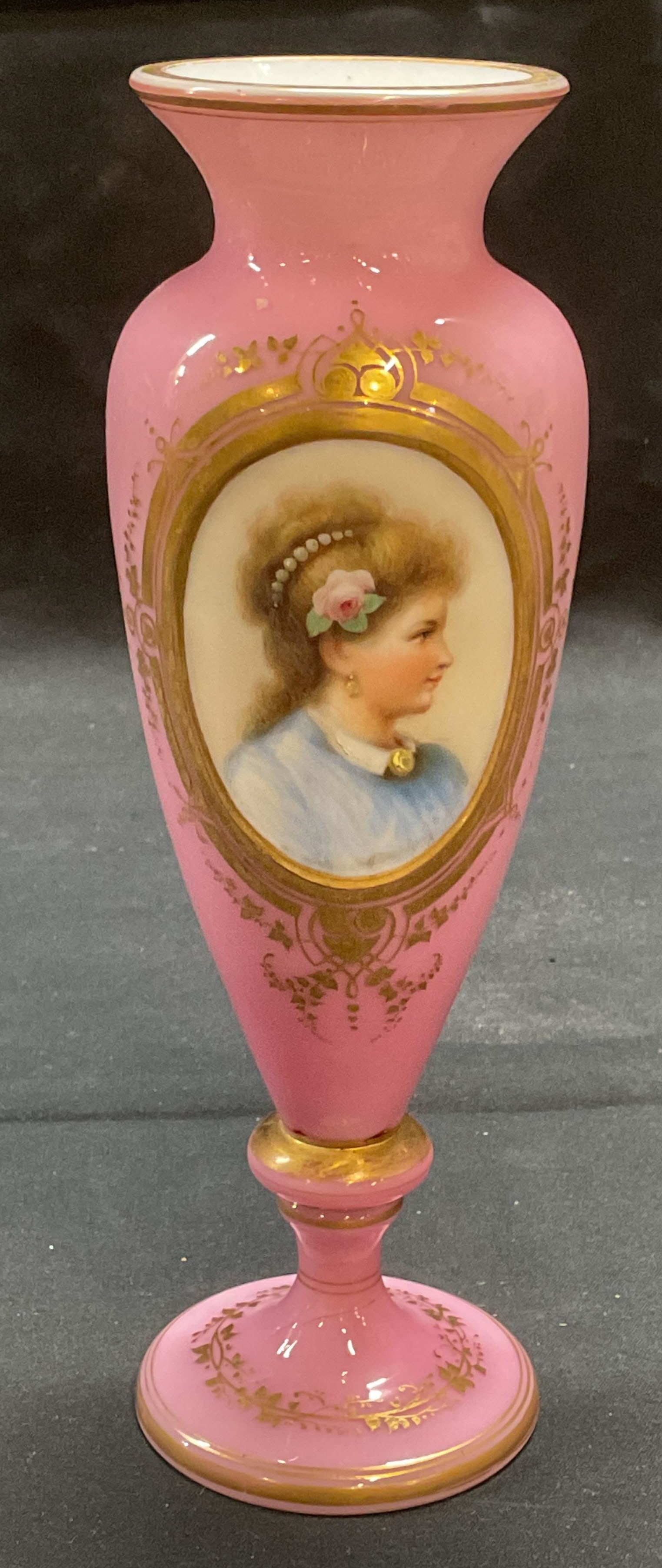 Vintage Opaline Pink Glass Portrait Vase: Vintage or antique Opaline pink glass portrait vase. Hand painted portrait of a woman with ornate gilt decoration. Measures approx. 2.5 x 7.75 inches. Some surface wear including scratching and loss t