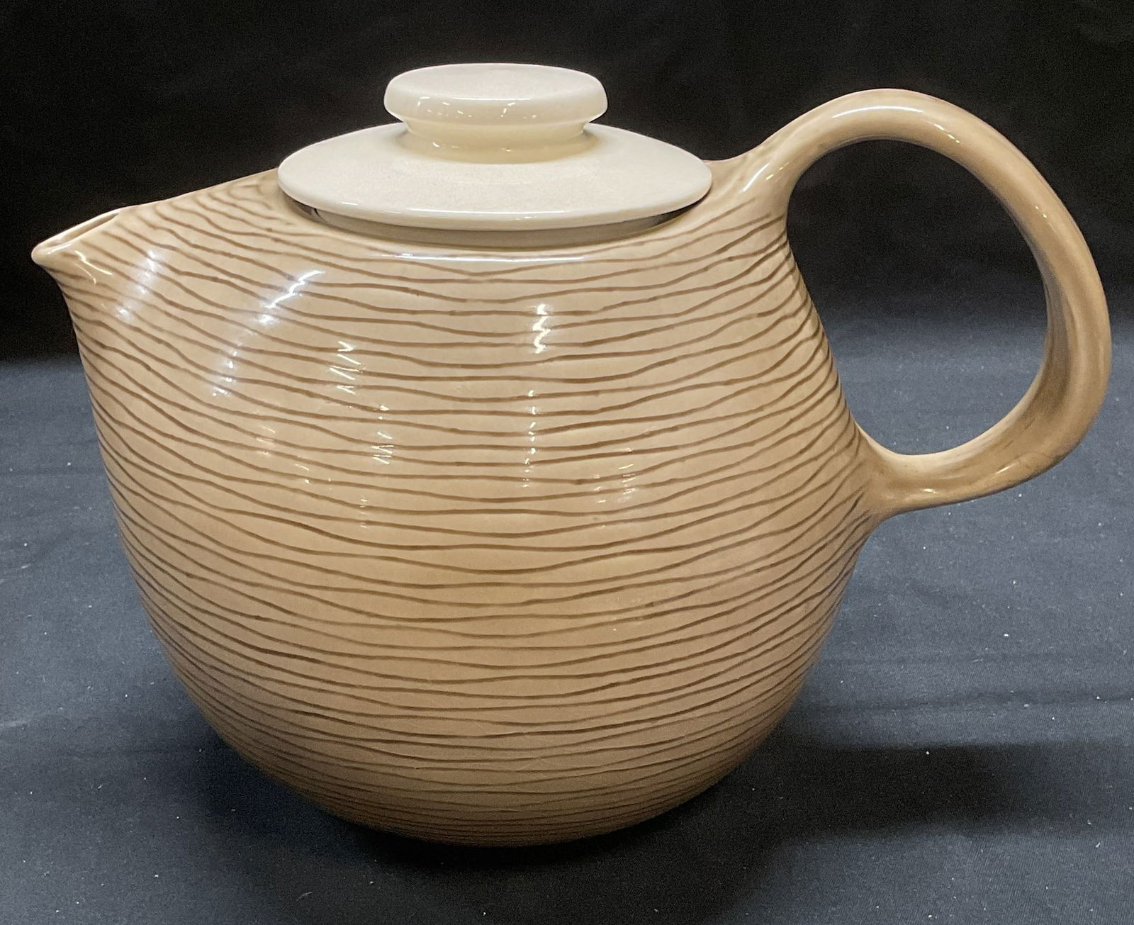 MCM Raymor Contempora Steubenville Teapot: Vintage mid century modern Raymor Contempora Steubenville ceramic teapot. Beside toned with wavy line pattern. Signed on underside. Measures approx, 9.5 x 6 x 7 inches. Some surface wear including scr