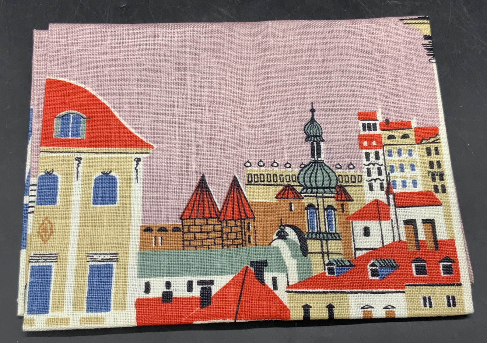 WARSZAWA J. SZYMCZAK Vintage Polish Tea Towel: A vintage multicolored linen tea towel featuring buildings to the obverse. Sticker reads All Pure Linen, Made in Poland, WARSZAWA. Obverse reads WARSZAWA, J. SZYMCZAK. Measures approx. 31.75L x 17W in