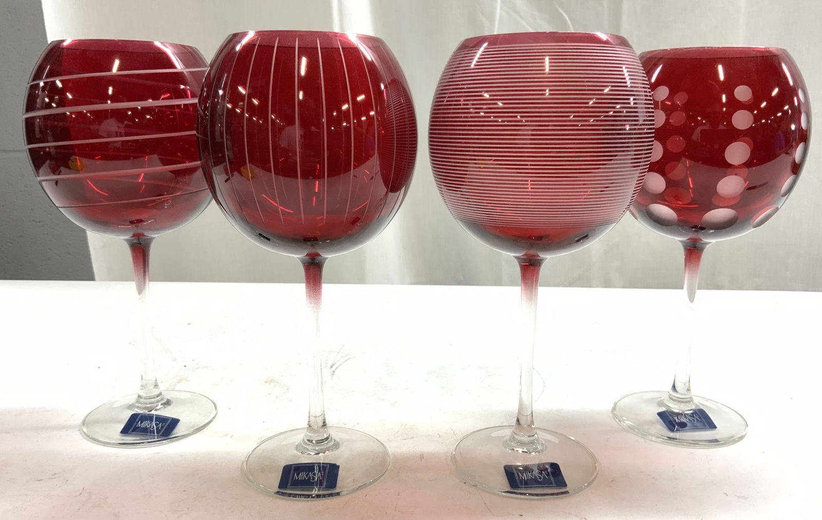 MIKASA Art Glass Goblets Vessels Cranberry: Tags read MIKASA Undersides of tags read CHEERS RUBY. Lot includes 4 goblets. Each are red toned with frosted detail including polka dot detail, horizontal Line detail, vertical line detail, & spiral