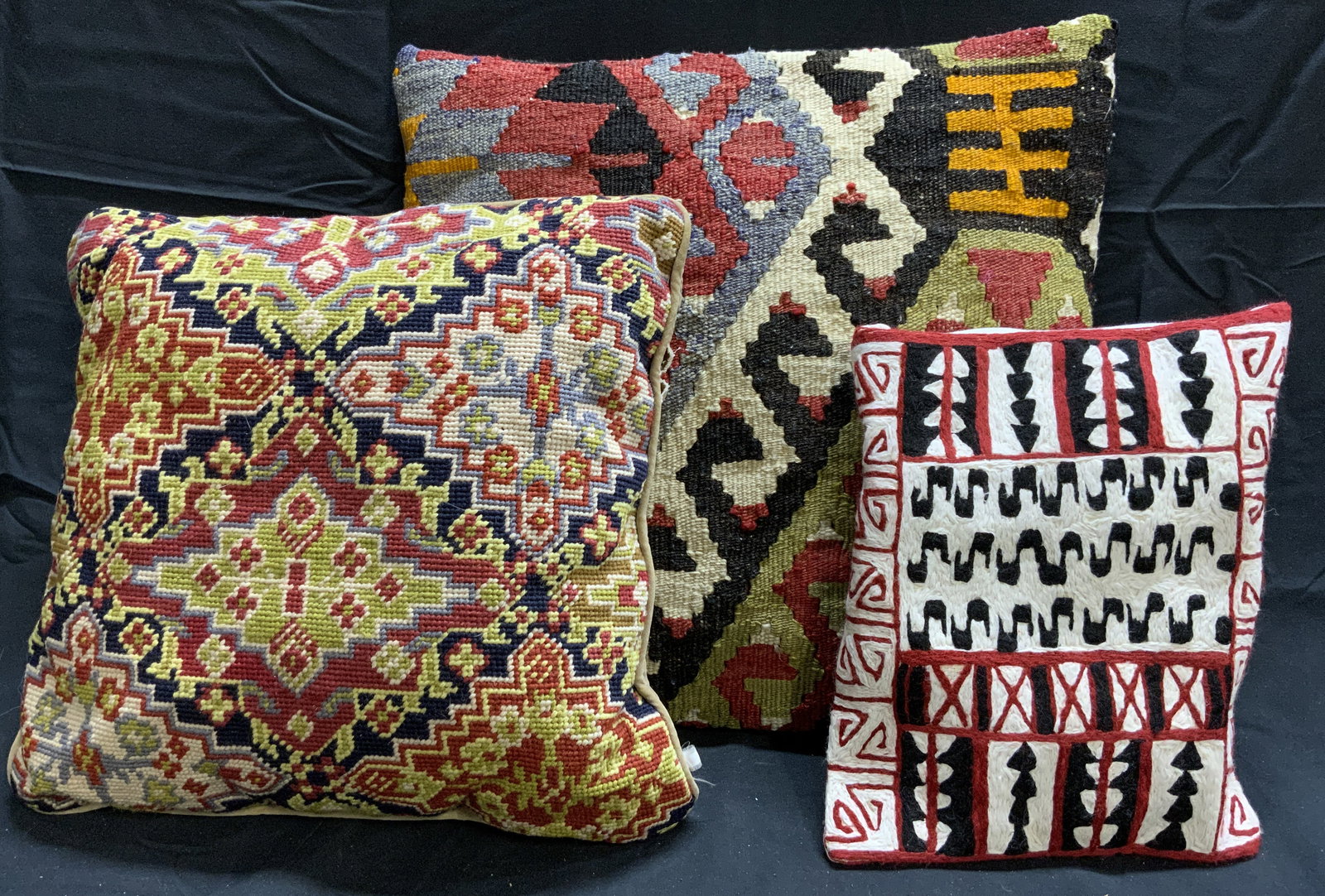 Lot 3 Kilim & Woven Pillows: Lot includes 3 woven pillows (1 Kilim pillow). Each pillow has multi toned geometric detail. One pillow has welted edges. Kilim pillow measures approximately 15 inches square. Pillows, kilim pillows,