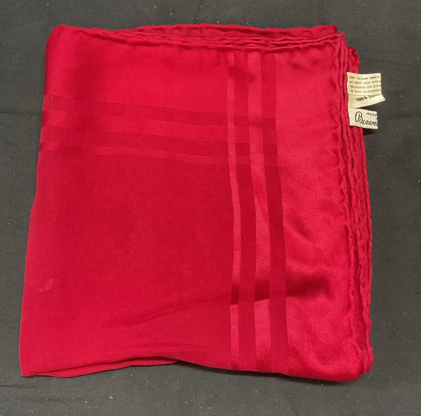 Bloomingdales Red Silk Scarf, Italy: Bloomingdales red silk scarf with hand rolled edge. Made in Italy. Measures approx. 34 x 33 inches. Some wear to material including small pulls and blemishes observed. Bloomingdales, Bloomingdales sca