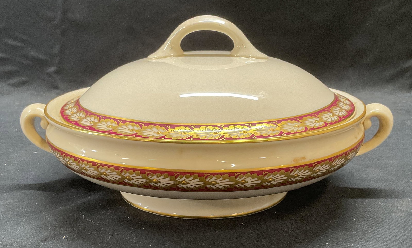 Lenox Pembroke Porcelain Lidded Bowl: Pembroke by Lenox porcelain bowl with lid. White with red and gilt border. Hand painted. Measures approx. 9 x 2.75 inches excluding lid. Trademarked to underside. Some surface wear including scratchin