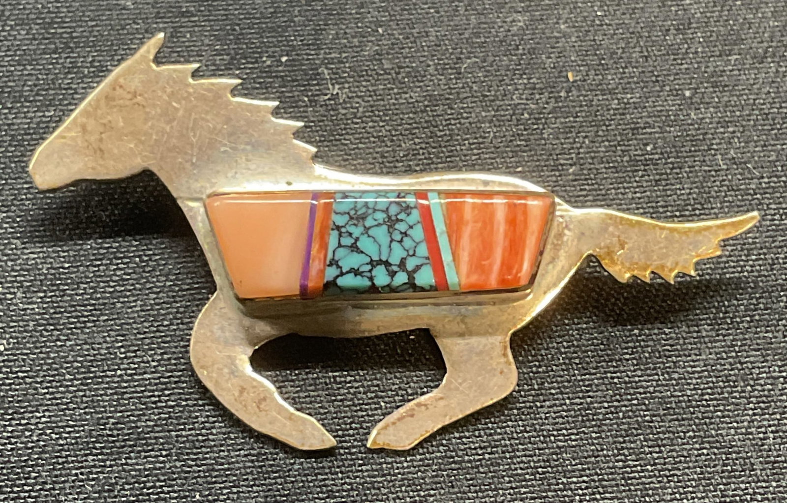 Sterling Silver Turquoise & Coral Horse Brooch: Sterling silver horse motif brooch with inlaid turquoise and coral. Measures approx. 1.5 x 1 inches. Total weight 3.3 grams. Tests for sterling using PuriTEST kit. Some surface wear including scratchi
