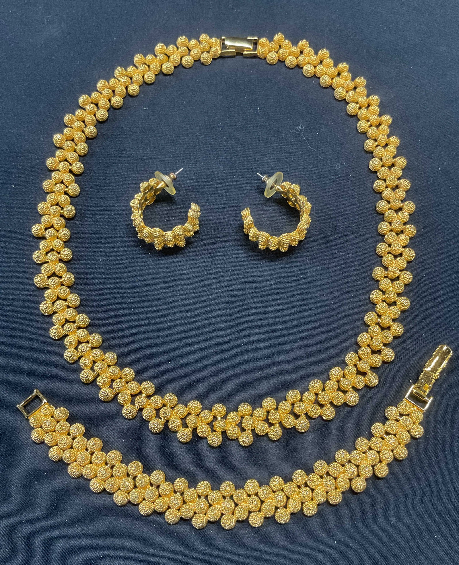 Set 3 Gold Tn Necklace, Bracelet & Earrings: Jewelry set of 3 pieces. Gold tone round textured choker necklace, bracelet, and half hoop earrings. Necklace drop length approx. 7 inches. Bracelet measures approx. 6 inches long. Earring measure app