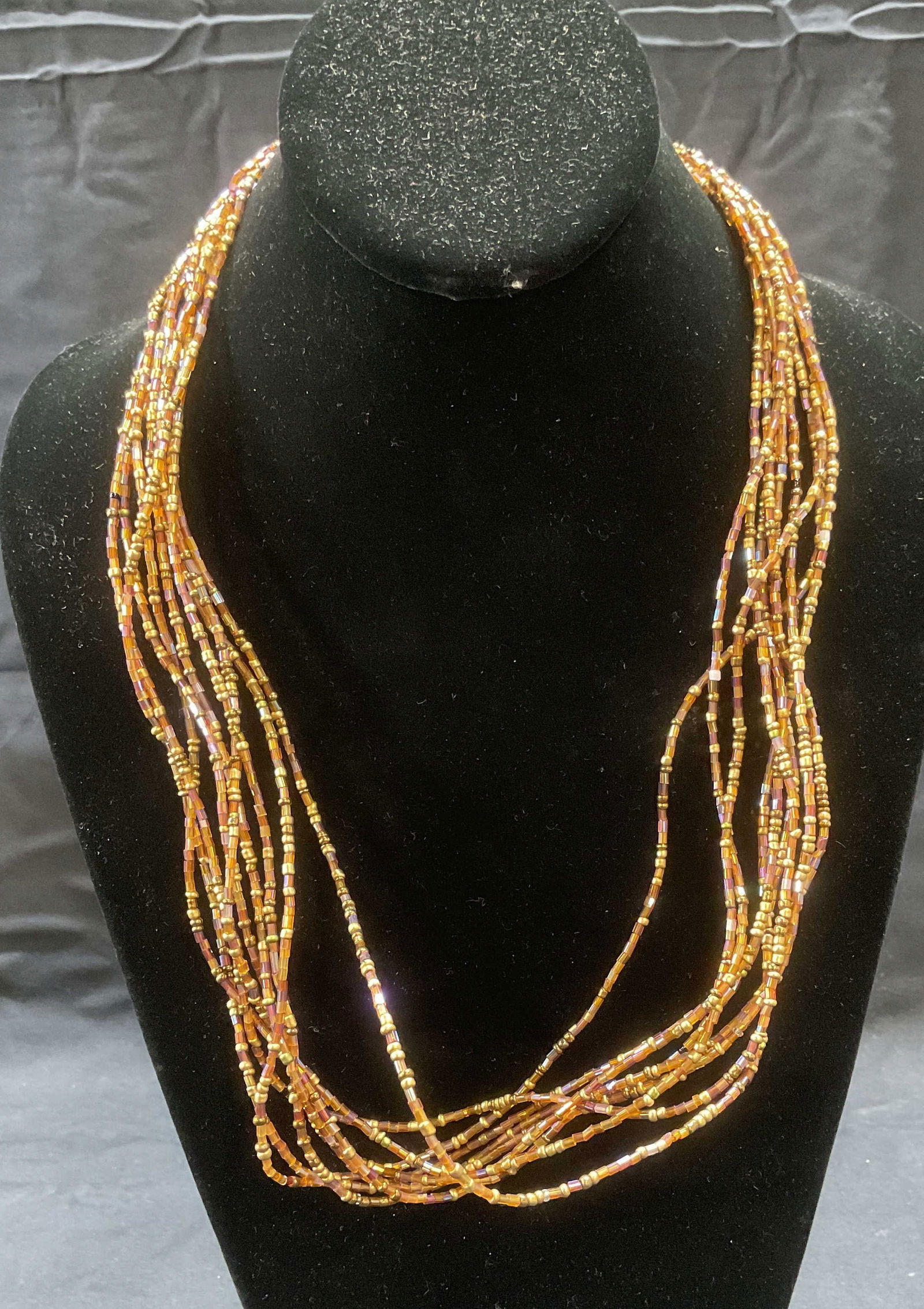 Good Tone Beaded Multi Strand Necklace: Gold tone seed beaded multi strand necklace. Drop length approx. 12 inches. Some surface wear including scratching observed. Jewelry, estate jewelry, costume jewelry, cocktail jewelry, fashion jewelry