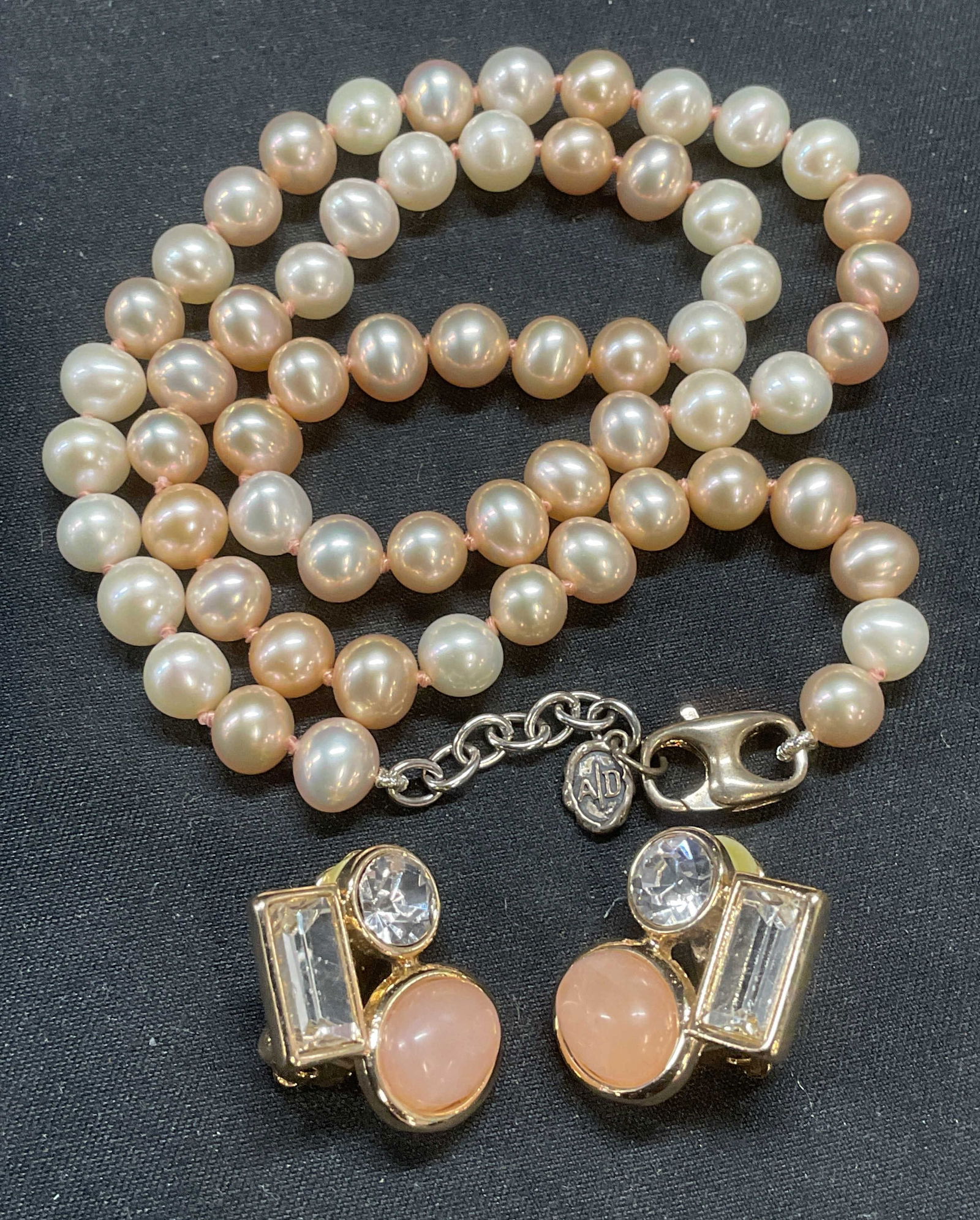 Lot 2 AD Pink & White Pearl Necklace +: Lot of 2 jewelry pieces. AD pink and white beaded pearl necklace on double knotted string with sterling silver clasp. Total weight 28.3 grams. Drop length approx. 8.5 inches. Signed on hang tag, sterl