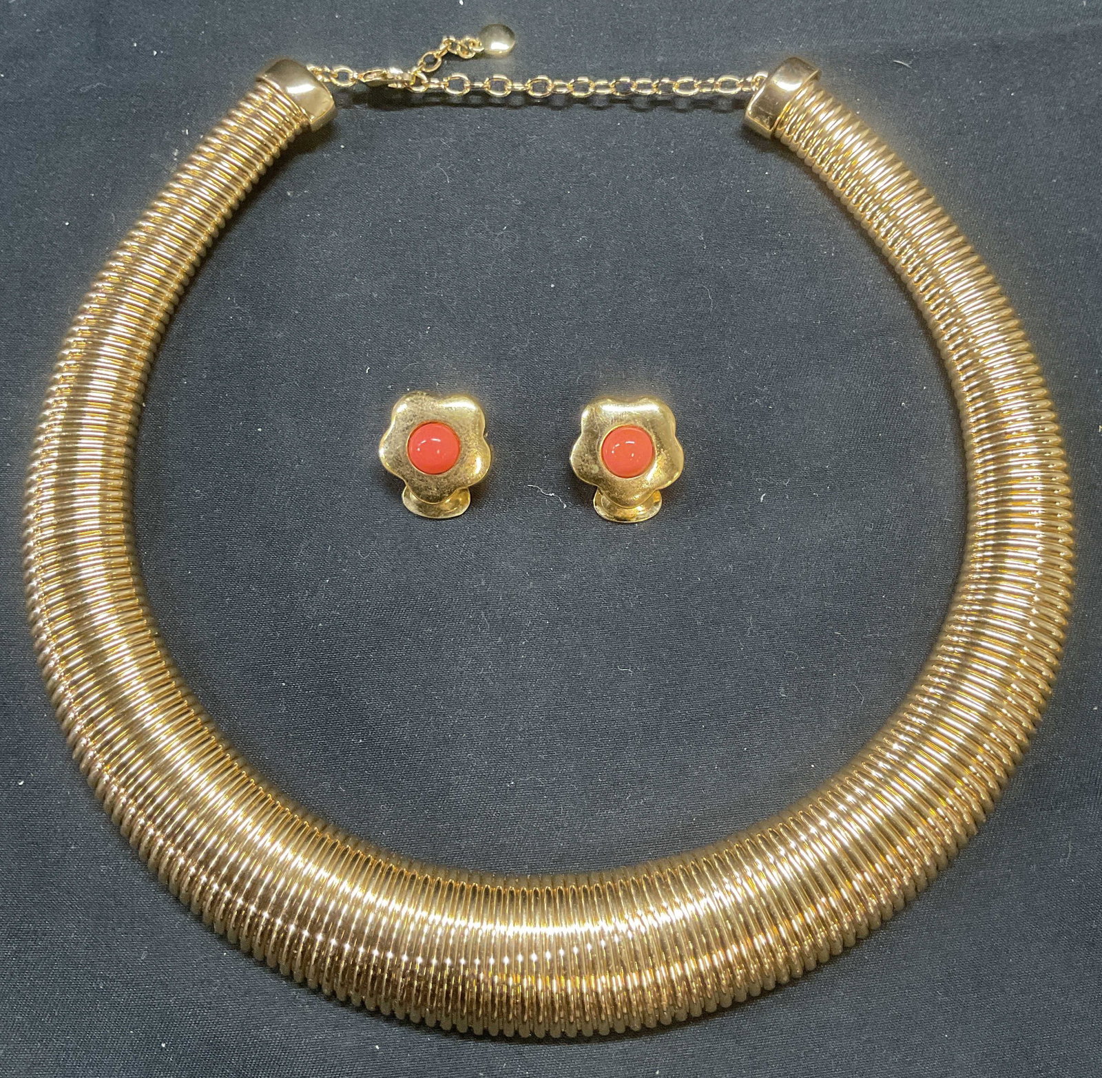 Lot 2 Baublebar Gold Tone Choker Necklace +: Lot of 2 jewelry pieces. Baublebar gold tone accordion chain choker necklace. Signed on hang tag. Drop length approx. 6 inches. Flower motif earrings with coral cabochons. Possibly gold plated or fill