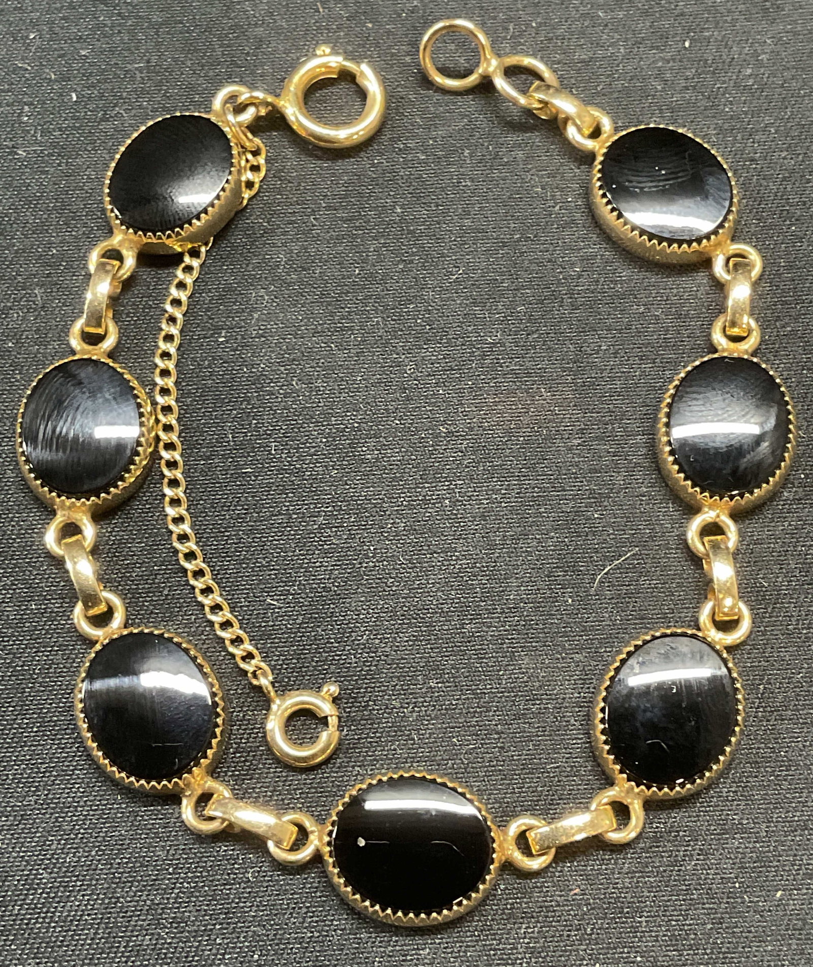 Vntg Burt Cassell 12k GF Black Stone Bracelet: Vintage Burt Cassell 12k gold filled bracelet with black stone panels. Signed on underside. 12k gold filled. Measures approx. 7 inches long. Some surface wear including scratching observed. Jewelry, e