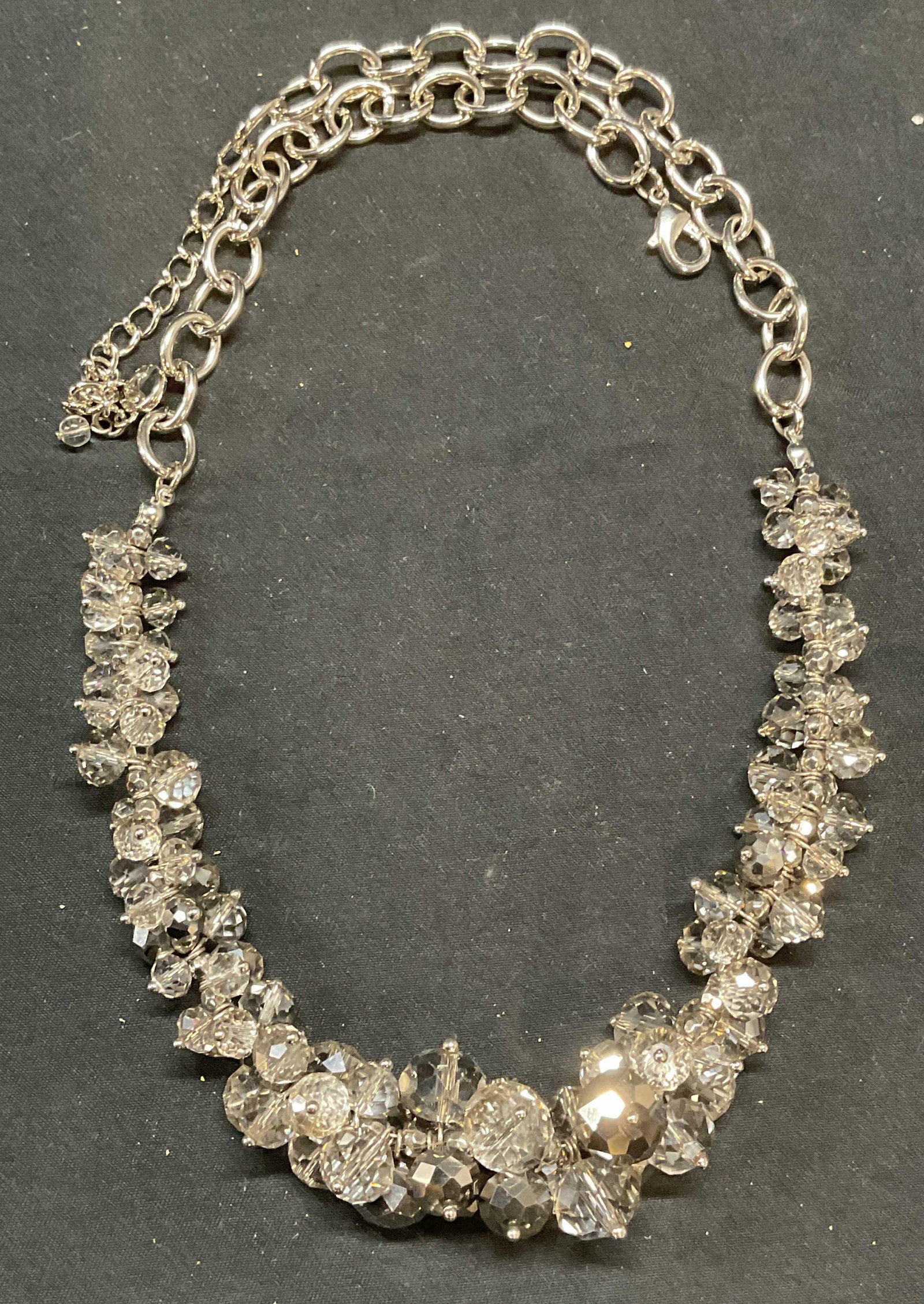 Signed Silver Tone Crystal Beaded Necklace: Signed silver tone necklace with colorless and metallic toned crystal beads. Signed in hang tag, drop length approx. 10.5 inches. Some surface wear including scratching observed. Chain needs untanglin