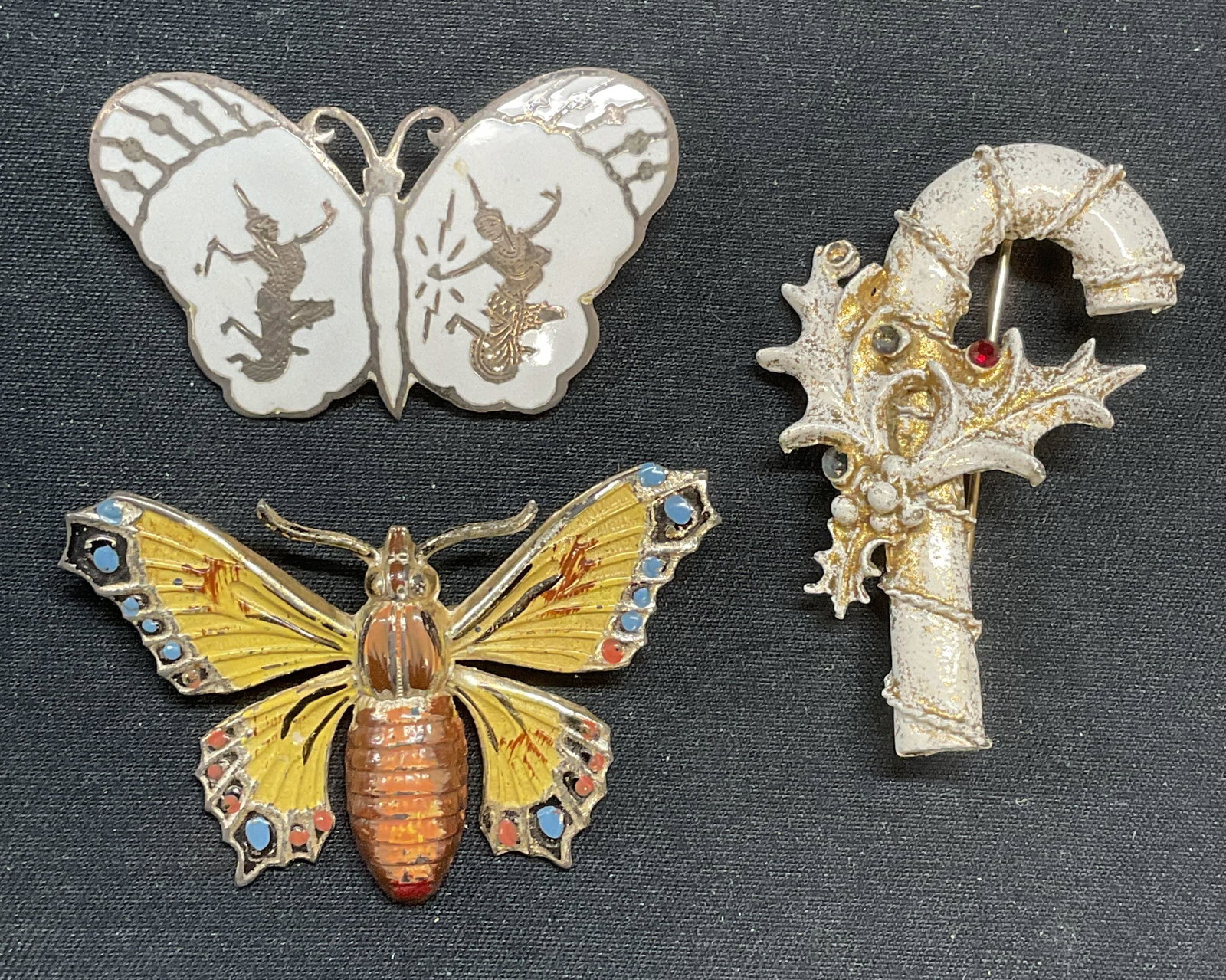 Lot 3 Vntg Sterling Silver Butterfly Brooch, More: Lot of 3 jewelry pieces. 2 butterfly motif and 1 candy cane and holly motif brooches. Enamel and crystal decoration. 1 vintage butterfly brooch with Asian dancer motif and white enamel marked sterling