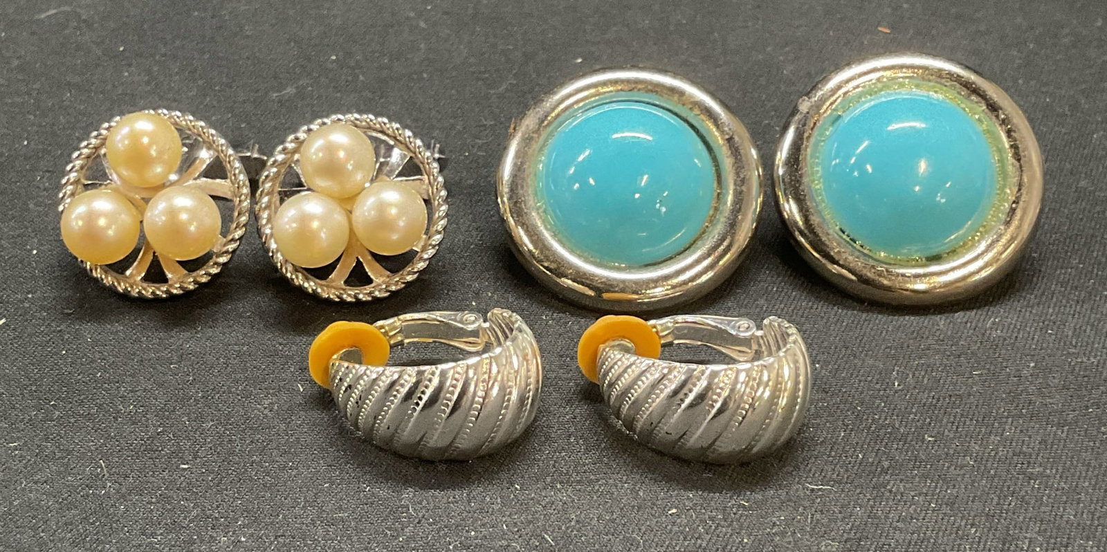 Lot 3 Silver Tn Turquoise Cabochon Earrings +: Lot of 3 jewelry pieces. Silver tone clip on earrings with turquoise style cabochons. Silver tone clip on earrings with raised ribbed detail. Silver tone and faux pearl decorated cufflinks. Largest pi