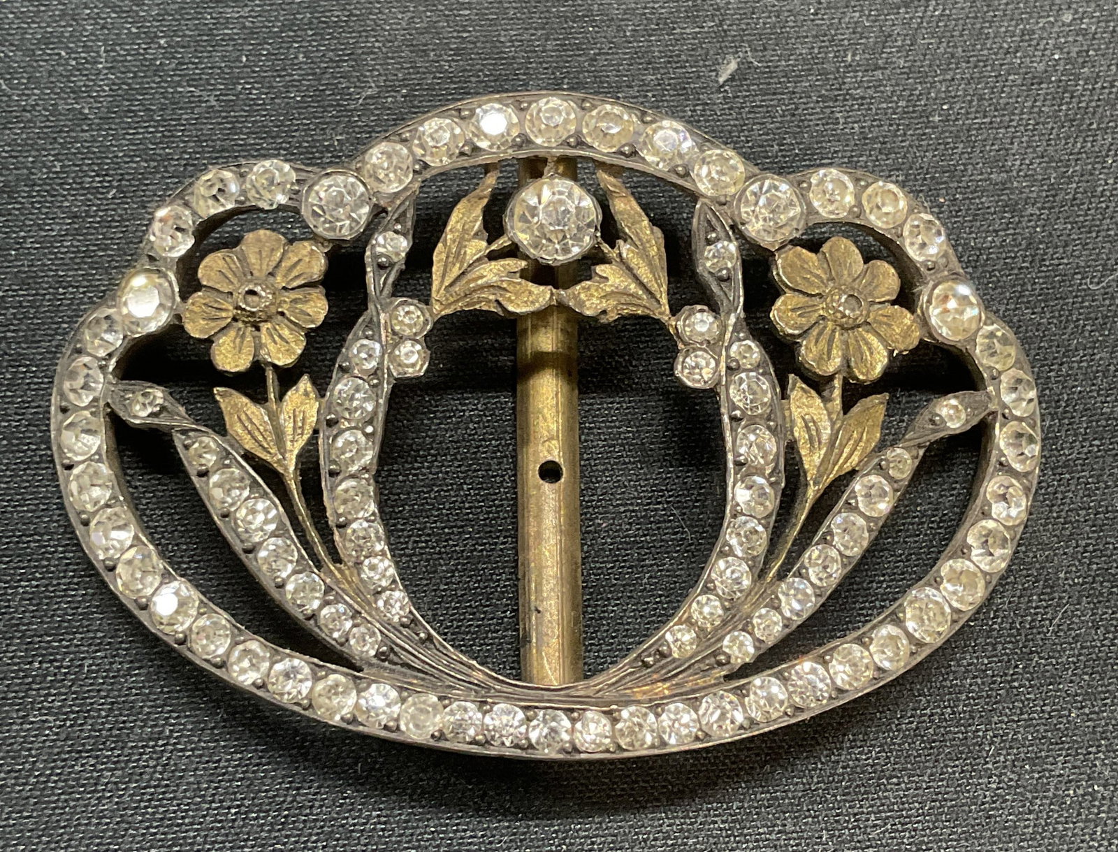 Antique Gold Tone Crystal Flower Buckle: Antique gold tone flower motif belt or shoe buckle with colorless crystal decoration. Measures approx. 2 x 1 3/8 inches. Some surface wear including scratching observed. Jewelry, estate jewelry, costu