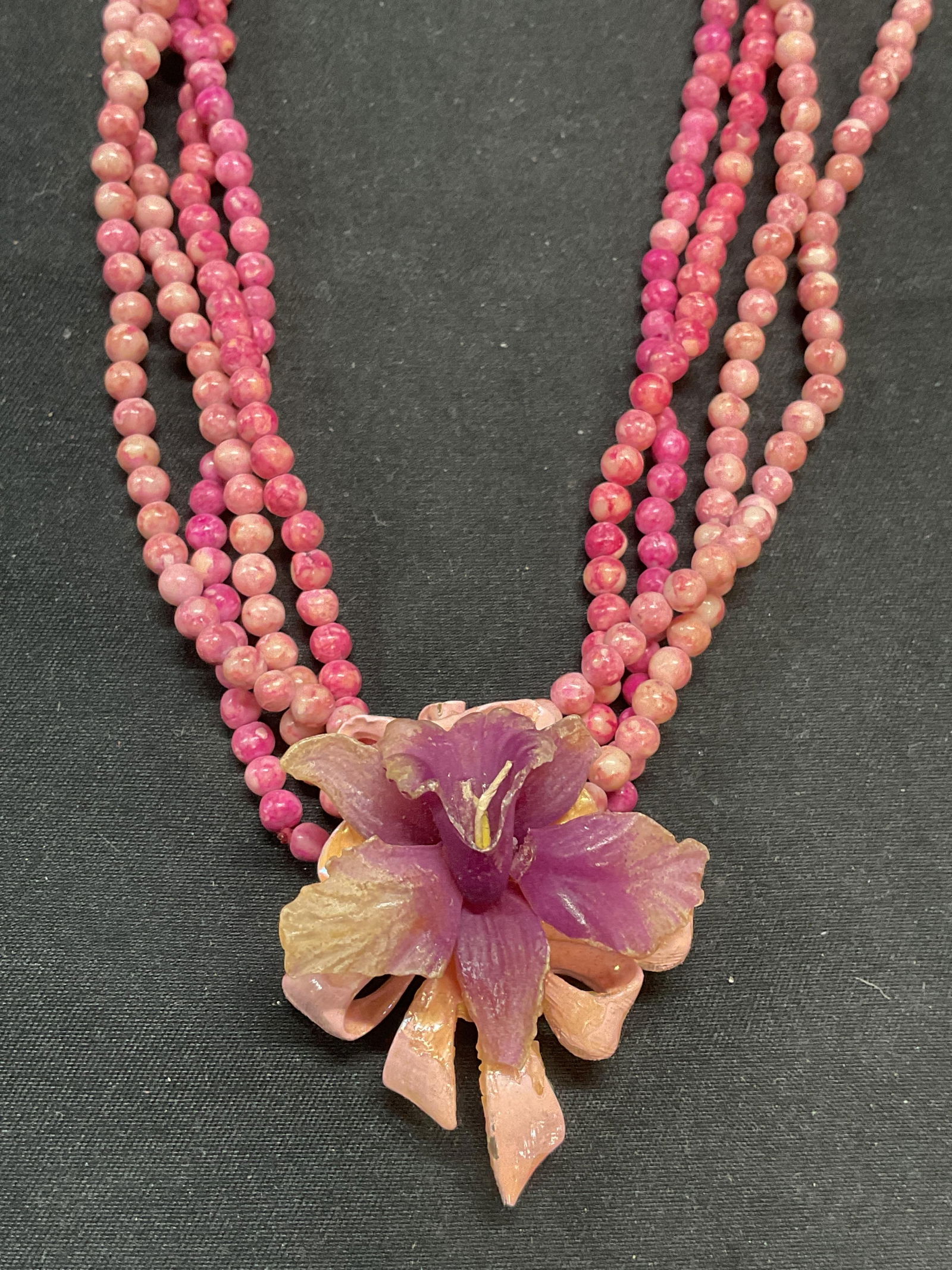Pink Beaded Stone Necklace w Flower Pendant: 4 Pink beaded stone necklaces with pink and purple toned enameled flower brooch/pendant. Necklace drop length 16.5 inches. Brooch measures approx. 1.75 x 1.5 inches. All pieces have some surface wear