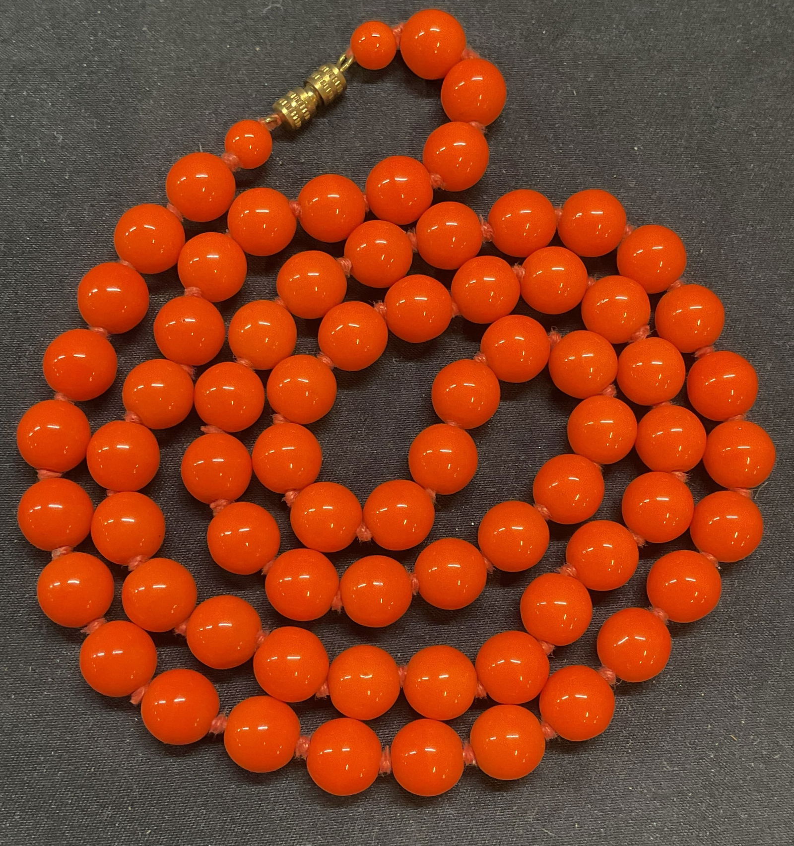 Vintage Orange Round Beaded Necklace: Vintage orange round beaded necklace on double knotted string. Drop length approx. 15 inches. Some surface wear including scratching observed. Jewelry, estate jewelry, costume jewelry, cocktail jewelr