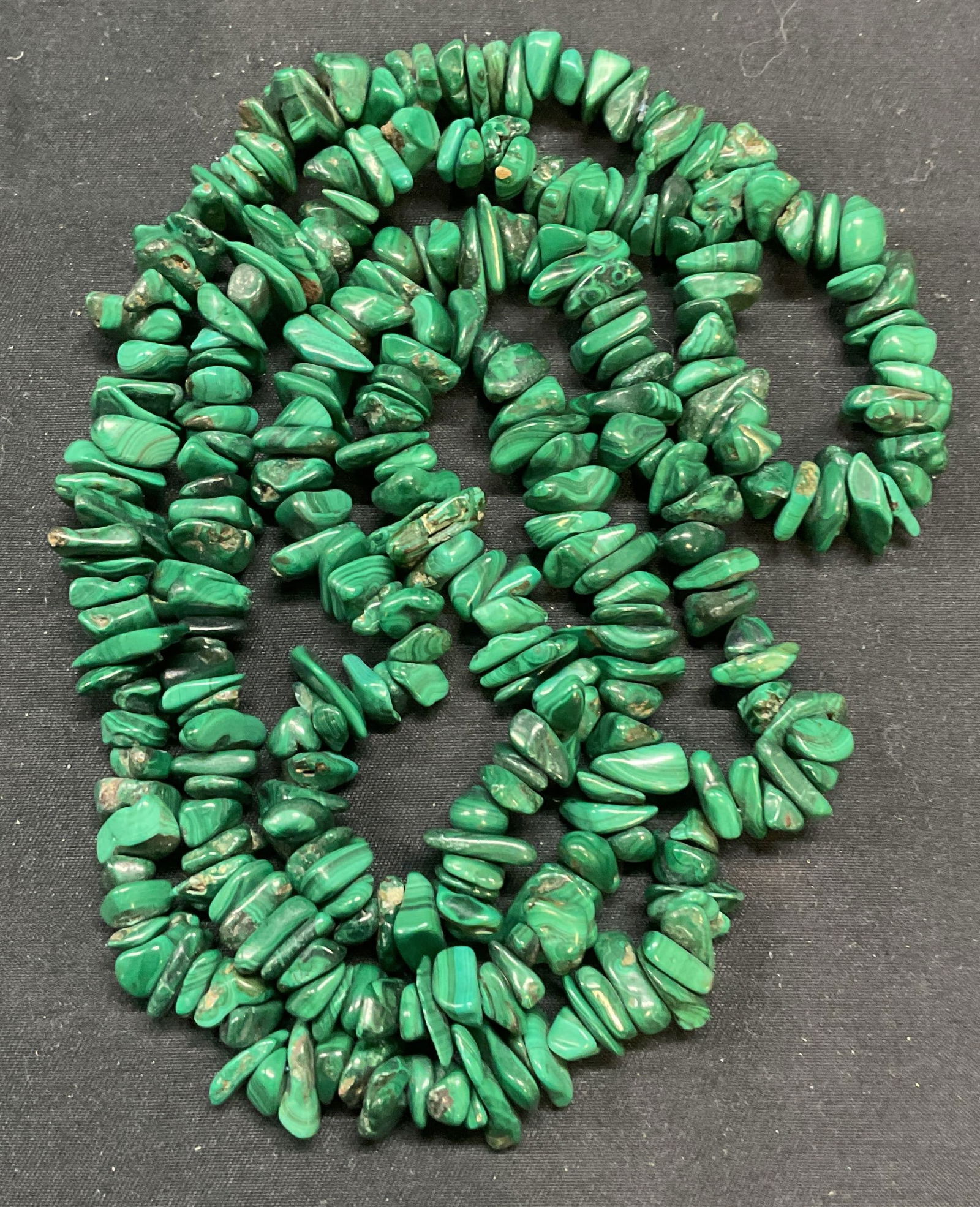 Malachite Chip Beaded Necklace: Malachite chip beaded necklace. Drop length approx. 17 inches. Necklace has weight. Total weight 166.7 grams. Some surface wear including scratching observed. Jewelry, estate jewelry, costume jewelry,