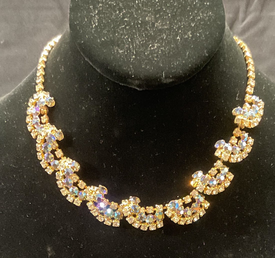 Vintage Gold Tone Blue Crystal Necklace: Vintage gold tone necklace with blue and colorless crystal decoration. Drop length approx. 7.5 inches. Some surface wear including scratching observed. Jewelry, estate jewelry, costume jewelry, cockta