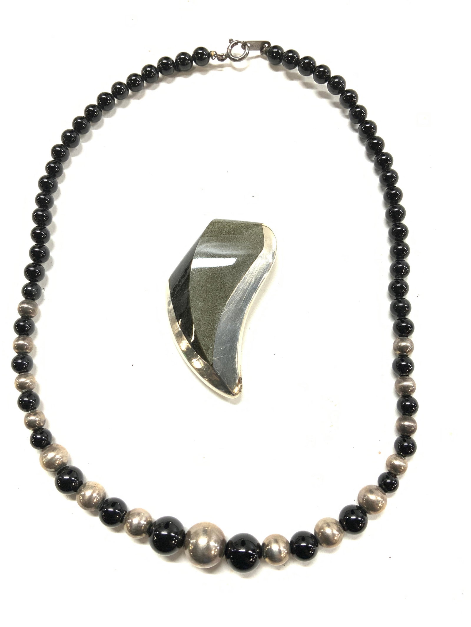 2 Sterling Silver Jewelry, Mexican Brooch & More: Mexican sterling silver brooch, marked .925 and Tedesma , Taxco Mexico. Measures 2.25 x 1 in. .59 ozt Necklace with sterling silver and onyx beads, marked 925 on clasp. Weights 25.4 grams tw. 6 in. Dr