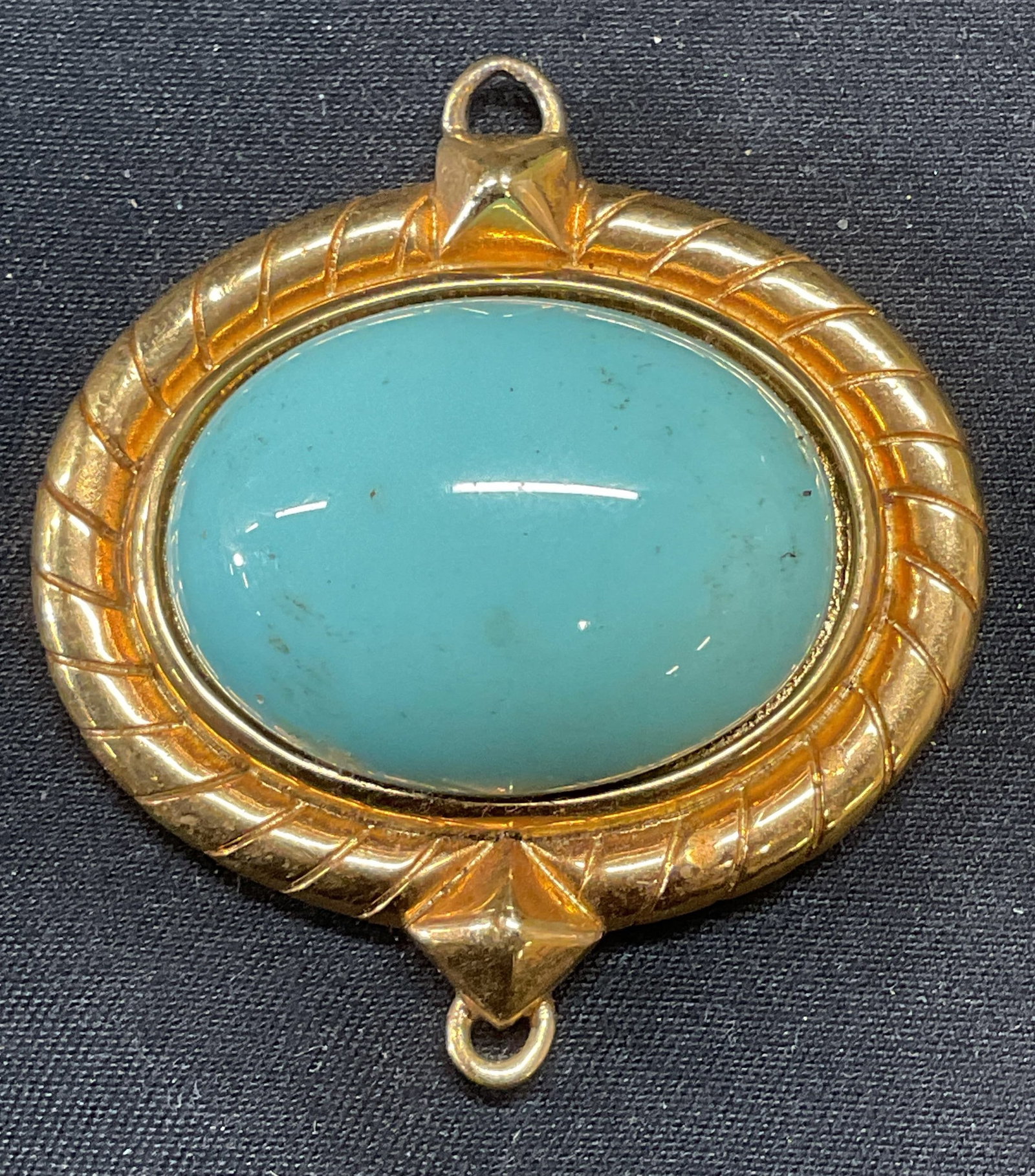 Vntg SMB Gold Tone Turquoise Cabochon Pendant: Vintage Sandra Miller Burrows gold tone pendant with turquoise cabochon decoration. Signed SMB to underside. Measures approx. 1.5 x 1.5 inches. Some surface wear including scratching observed. Jewelry