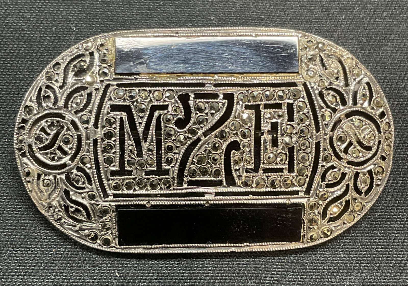 Vntg Sterling Silver & Marcasite Monogram Brooch: Vintage sterling silver monogram brooch with marcasite and black stone inlay decoration. Hinge pin to underside. Measures approx. 1.5 x 1 inches. Tests for sterling using PuriTEST kit. Total weight 10